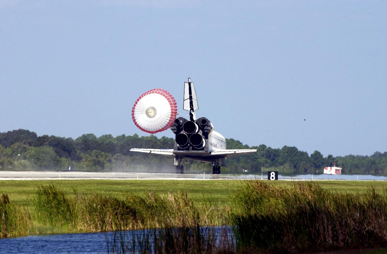 KENNEDY SPACE CENTER, FLA. --  Its drag chute deployed, Space Shuttle Atlantis slows to a stop after touchdown on Runway 33 at the Shuttle Landing Facility, completing the 4.5-million-mile journey to the International Space Station.  Main gear touchdown occurred at 11:43:40 a.m. EDT; nose gear touchdown at 11:43:48 a.m.; and wheel stop at 11:44:35 a.m.  Mission elapsed time was 10:19:58:44.  Mission STS-112 expanded the size of the Station with the addition of the S1 truss segment.  The returning crew of Atlantis are Commander Jeffrey Ashby, Pilot Pamela Melroy, and Mission Specialists David Wolf, Piers Sellers, Sandra Magnus and Fyodor Yurchikhin. This landing is the 60th at KSC in the history of the Shuttle program.        .    