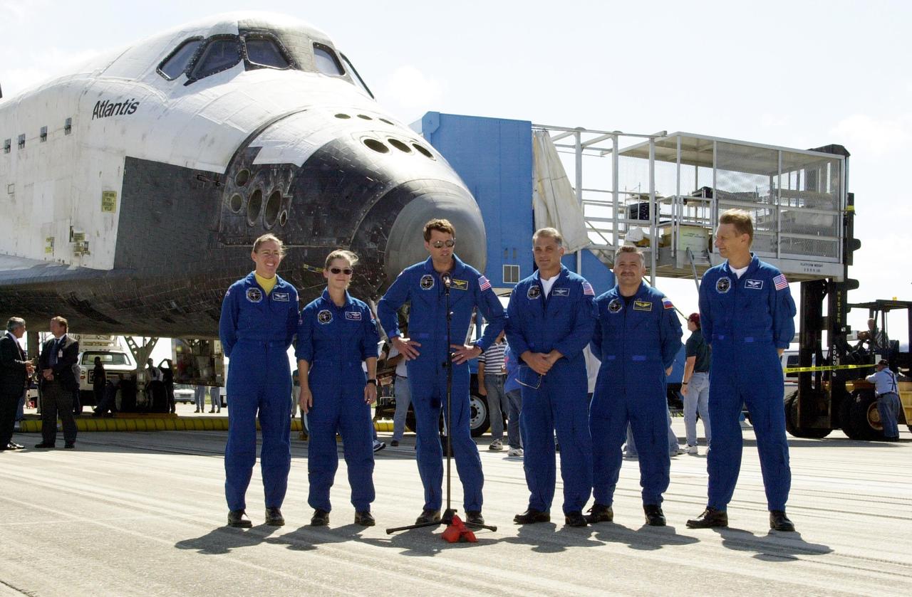 KENNEDY SPACE CENTER, FLA. - The STS-112 crew pauses at the microphone in front of Atlantis after exiting the crew transport vehicle.  From left are Mission Specialist Sandra Magnus, Pilot Pamela Melroy, Commander Jeffrey Ashby, and Mission Specialists David Wolf, Fyodor Yurchikhin and Piers Sellers.  The flawless landing of Space Shuttle Atlantis on Runway 33 at KSC completed a 4.5-million-mile journey to the International Space Station. Main gear touchdown occurred at 11:43:40 a.m. EDT; nose gear touchdown at 11:43:48 a.m.; and wheel stop at 11:44:35 a.m.  Mission elapsed time was 10:19:58:44.  Mission STS-112 expanded the size of the Station with the addition of the S1 truss segment.  