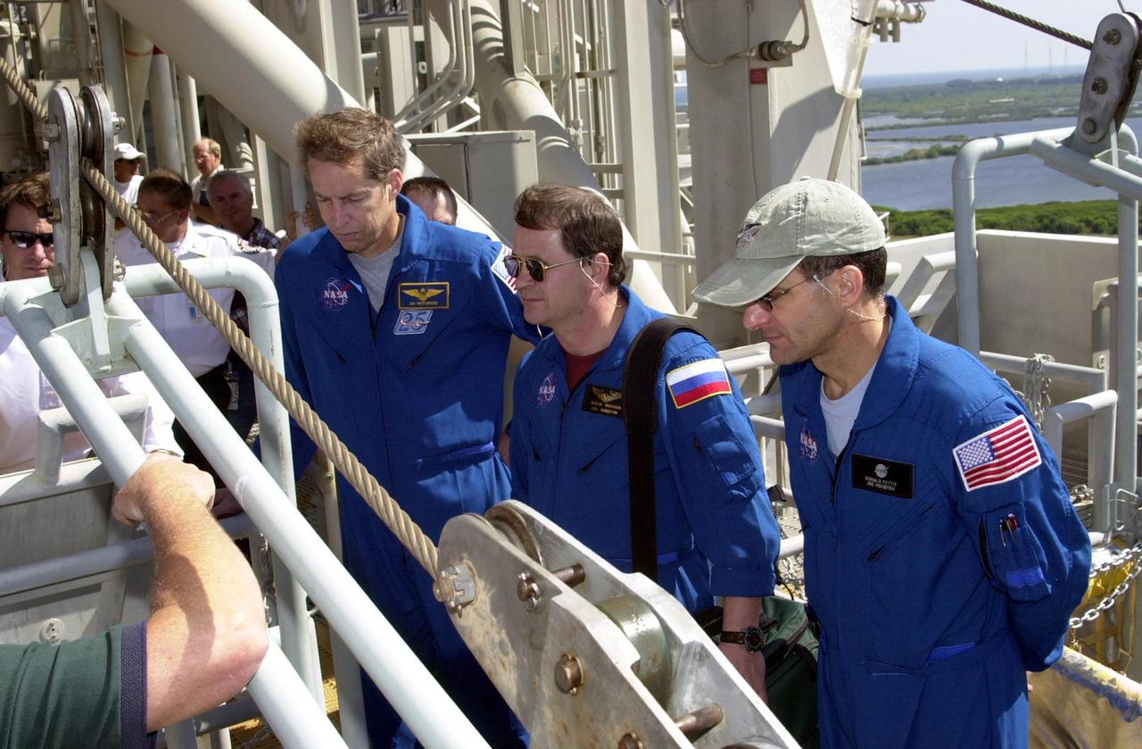 KENNEDY SPACE CENTER, FLA. - As part of Terminal Countdown Demonstration Test (TCDT) activities, the STS-113 and Expedition 6 crews receive training in emergency exit from the orbiter on Launch Pad 39A. Shown are (from left) Mission Commander James Wetherbee and cosmonaut Nikolai Budarin and astronaut Donald Pettit of the Expedition 6 crew. The TCDT also includes a simulated launch countdown. The 16th assembly flight to the International Space Station, STS-113 will carry the Port 1 (P1) truss aboard Space Shuttle Endeavour as well as the Expedition 6 crew, who will replace Expedition 5 on the Station. Mission STS-113 is scheduled to launch Nov. 10, 2002.