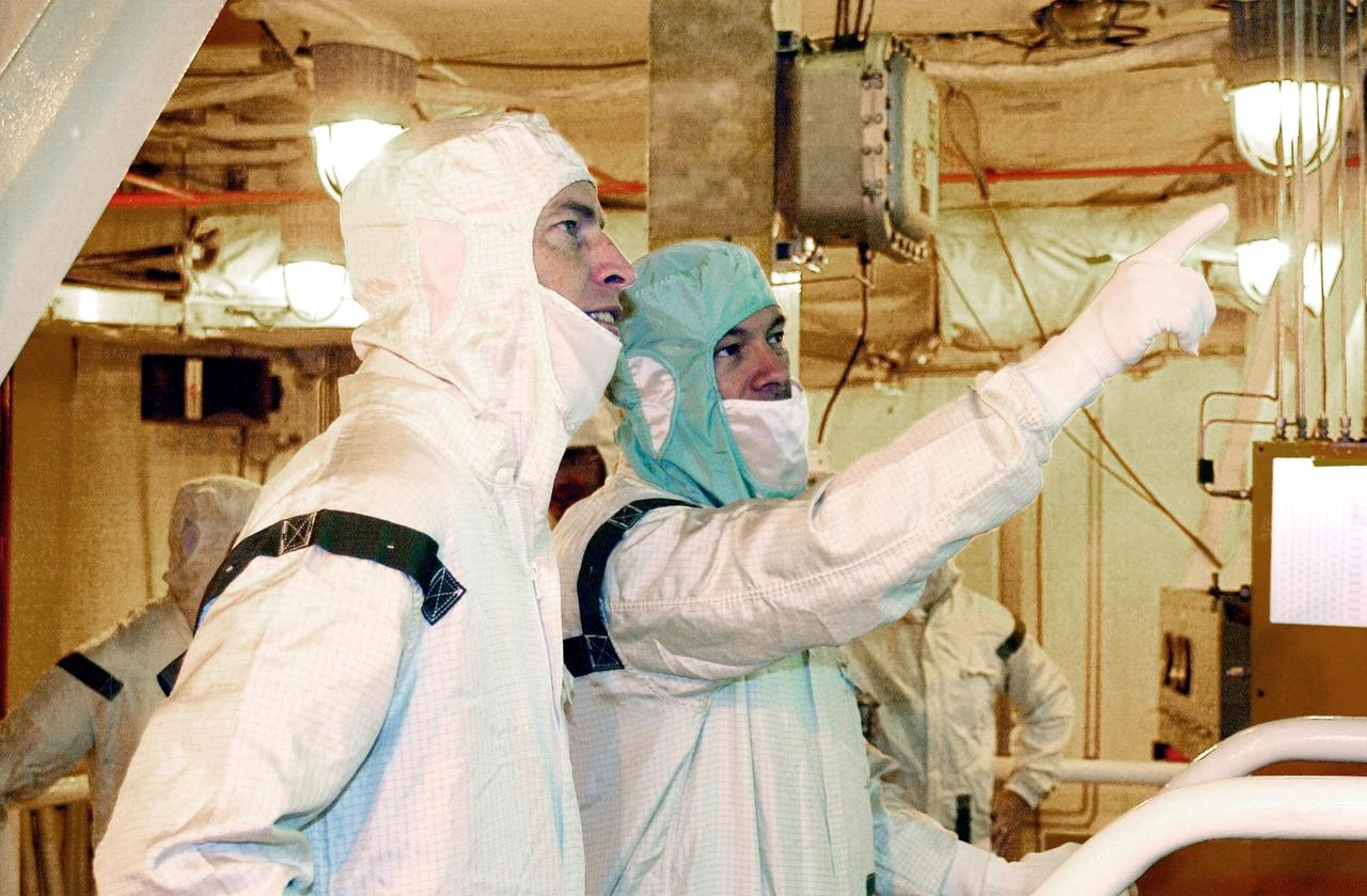 KENNEDY SPACE CENTER, FLA. - On a platform in Endeavour's payload bay, STS-113 Commander James Wetherbee (left) looks at part of the payload being pointed out by a worker. The 16th assembly flight to the International Space Station, STS-113 will carry the Port 1 (P1) truss aboard Space Shuttle Endeavour as well as the Expedition 6 crew, who will replace Expedition 5 on the Station. Mission STS-113 is scheduled to launch Nov. 10, 2002.   