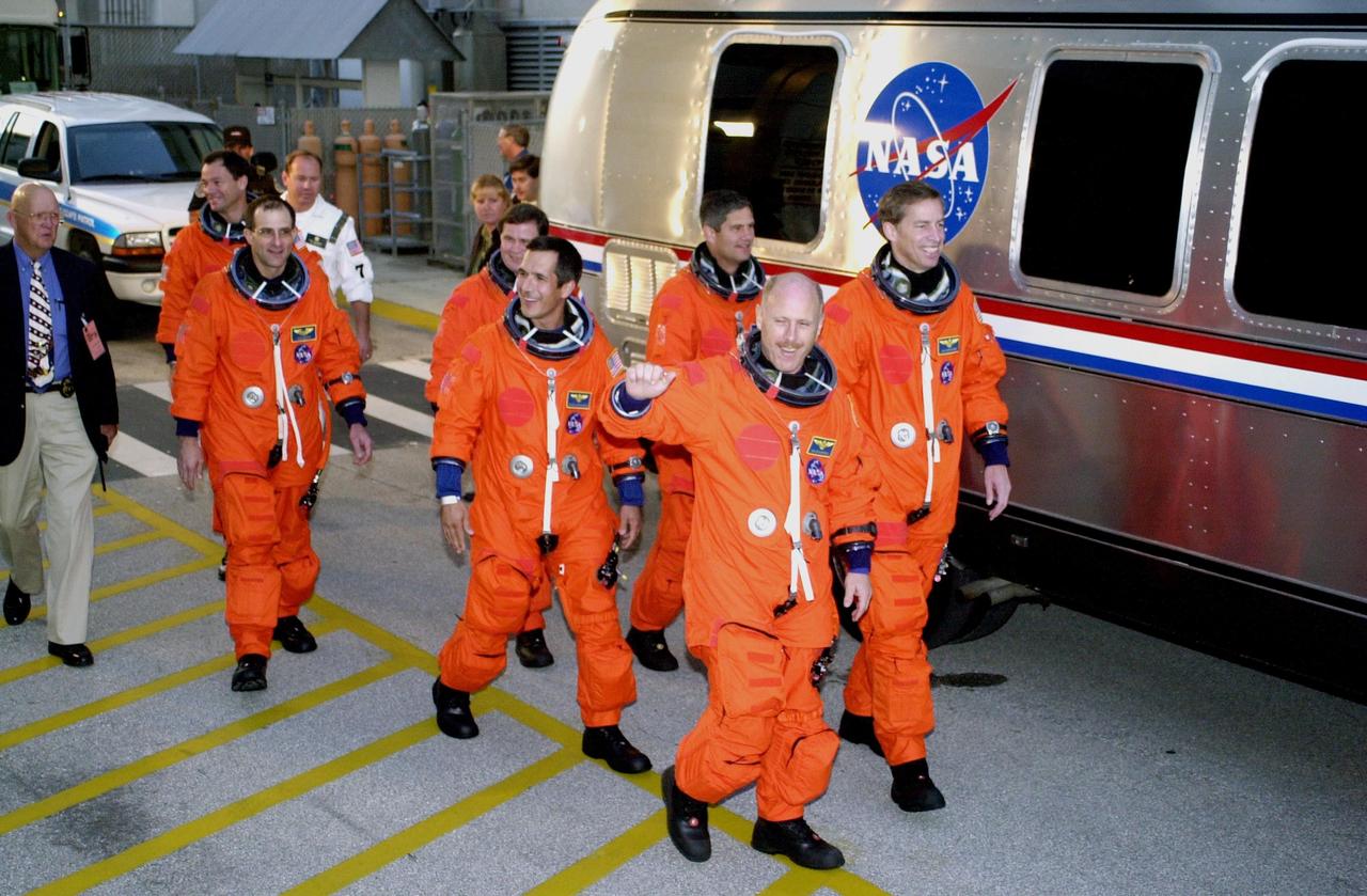 KENNEDY SPACE CENTER, FLA. -- The STS-113 and Expedition 6 crews head for the Astrovan to take them to Launch Pad 39A for a simulated launch countdown.  From  left are STS-113 Mission Specialist Michael Lopez-Alegria, Expedition 6 astronaut Donald Pettit and cosmonaut Nikolai Budarin, Mission Specialist John Herrington and Pilot Paul Lockhart, Expedition 6 Commander Ken Bowersox and STS-113 Commander James Wetherbee. .  The countdown is part of Terminal Countdown Demonstration Test activities prior to launch. The 16th assembly flight to the International Space Station, STS-113 will carry the Port 1 (P1) truss aboard Space Shuttle Endeavour as well as the Expedition 6 crew, who will replace Expedition 5 on the Station. Mission STS-113 is scheduled to launch Nov. 10, 2002. 