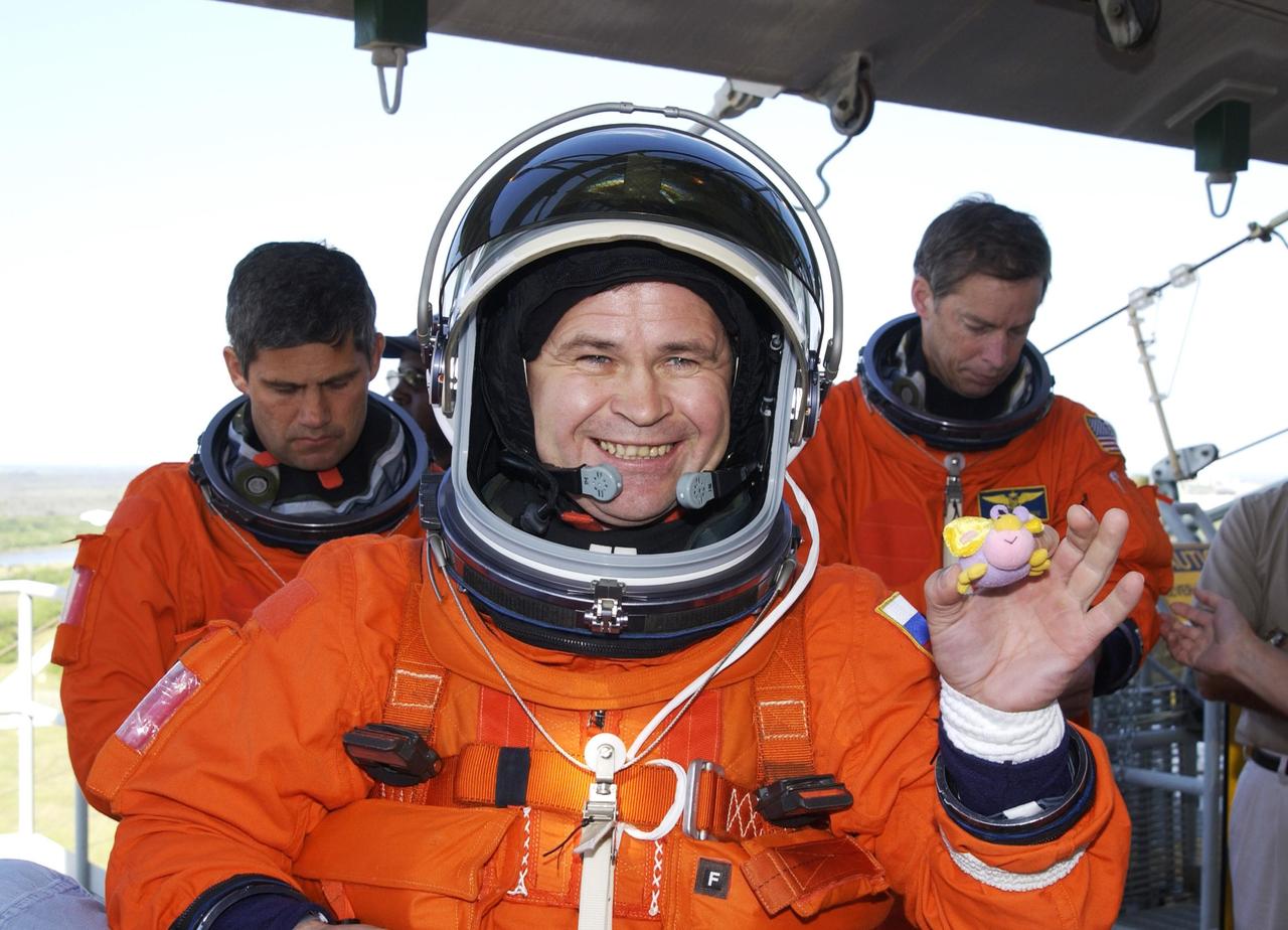 KENNEDY SPACE CENTER, FLA. - Expedition 6 cosmonaut Nikolai Budarin (center) holds a mini-mascot during a break in emergency egress practice from the 195-foot level of the Fixed Service Structure on Launch Pad 39A.  Behind him are STS-113 Pilot Paul Lockhart (left) and Commander James Wetherbee.  Expedition 6 will be replacing Expedition 5 on the International Space Station. The 16th assembly flight to the International Space Station, STS-113 will carry the Port 1 (P1) truss aboard Space Shuttle Endeavour.   The mission is scheduled to launch Nov. 10, 2002.        