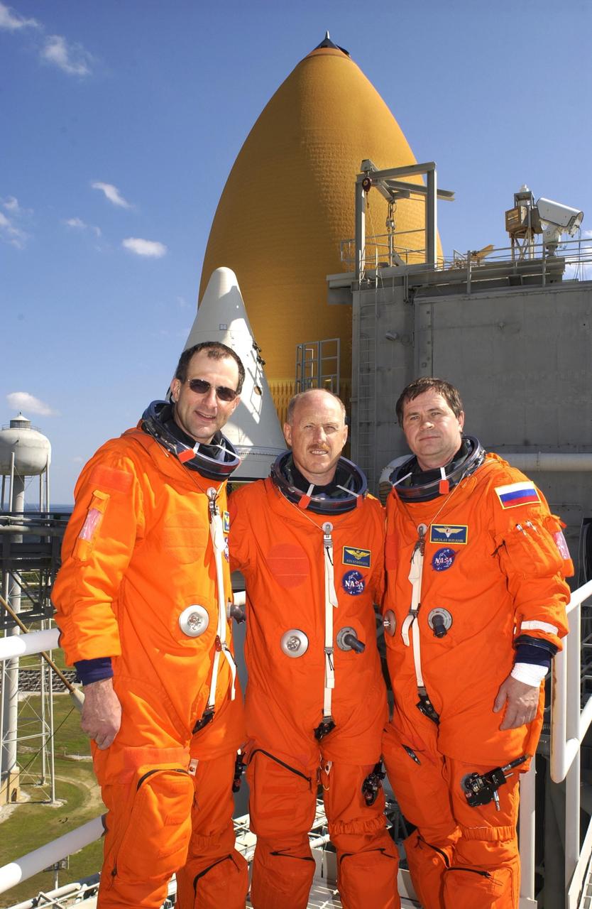 KENNEDY SPACE CENTER, FLA. - The Expedition 6 crew poses for a photo on 195-foot level of the Fixed Service Structure on Launch Pad 39A.  From left are astronaut Donald Pettit, Commander Ken Bowersox and cosmonaut Nikolai Budarin.  Along with the STS-113 crew, they have been participating in emergency egress training, part of Terminal Countdown Demonstration Test activities in preparation for their launch. The 16th assembly flight to the International Space Station, STS-113 will carry the Port 1 (P1) truss aboard Space Shuttle Endeavour, as well as Expedition 6, who will replace Expedition 5 on the Station. The mission is scheduled to launch Nov. 10, 2002.