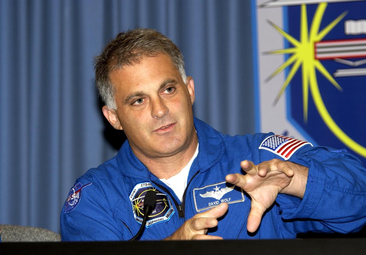 KENNEDY SPACE CENTER, FLA. --  STS-112 Mission Specialist David Wolf responds to a question during the crew's post-landing briefing for the media. Mission STS-112  was the 15th assembly flight to the International Space Station, installing the S1 truss.  The landing was the 60th at KSC in the history of the Shuttle program.