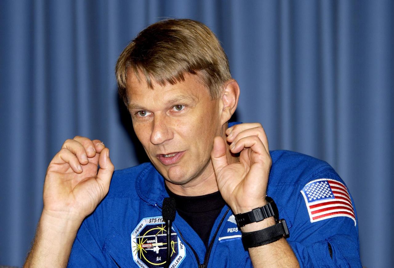 KENNEDY SPACE CENTER, FLA. -- STS-112 Mission Specialist Piers Sellers responds to a question during the crew's post-landing briefing for the media. Mission STS-112 was the 15th assembly flight to the International Space Station, installing the S1 truss. The landing was the 60th at KSC in the history of the Shuttle program.