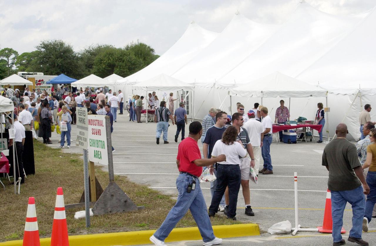 KENNEDY SPACE CENTER, FLA. --  KSC employees stroll an exhibit area, under tents, during Spaceport Super Safety & Health Day.  Dozens of presentations and exhibits across the Center focused attention on safety at work and home.