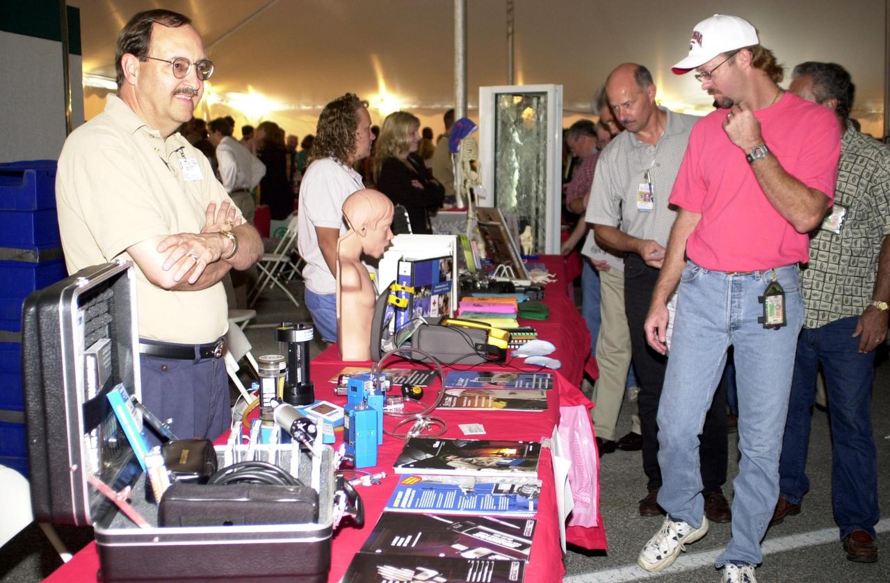 KENNEDY SPACE CENTER, FLA. --  KSC employees pass by displays set up under tents during Spaceport Super Safety & Health Day.  Dozens of presentations and exhibits across the Center focused attention on safety at work and home.