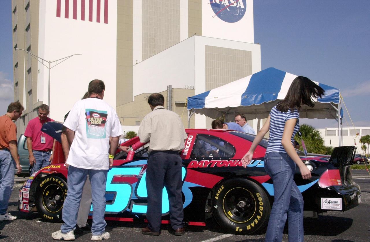 KENNEDY SPACE CENTER, FLA. -- KSC employees look over a race car on display during Spaceport Super Safety & Health Day.  Dozens of presentations and exhibits across the Center focused attention on safety at work and home.