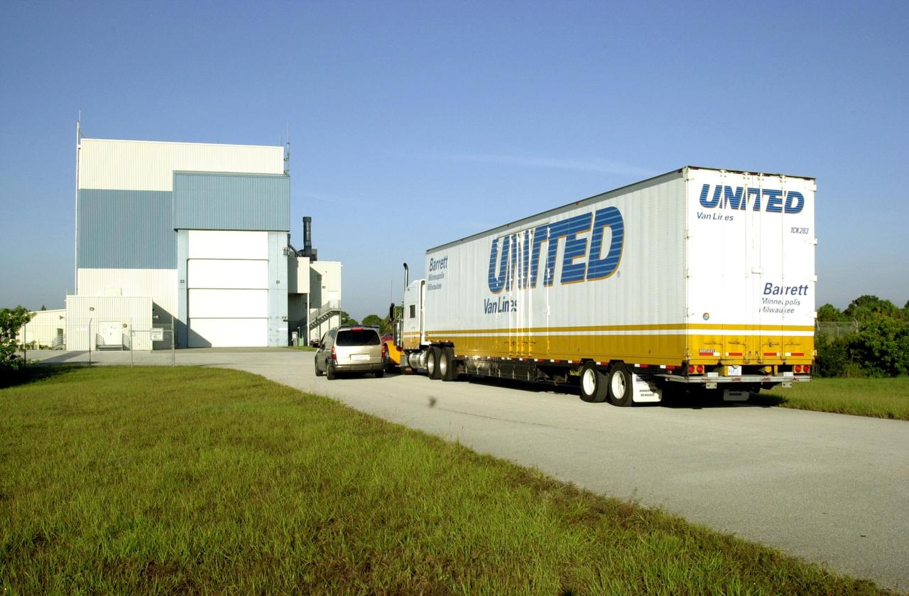 KENNEDY SPACE CENTER, FLA. -- A truck containing the Solar Radiation and Climate Experiment (SORCE) spacecraft approaches the Multi-Purpose Processing Facility at KSC. The spacecraft will undergo final processing for launch. SORCE is equipped with four instruments that will measure variations in solar radiation much more accurately than anything now in use and observe some of the spectral properties of solar radiation for the first time. With data from NASA's SORCE mission, researchers should be able to follow how the Sun affects our climate now and in the future. The SORCE project is managed by NASA's Goddard Space Flight Center. The instruments on the SORCE spacecraft are built by the Laboratory for Atmospheric and Space Physics (LASP). Launch of SORCE aboard a Pegasus XL rocket is scheduled for mid-December 2002. Launch site is Cape Canaveral Air Force Station, Fla.