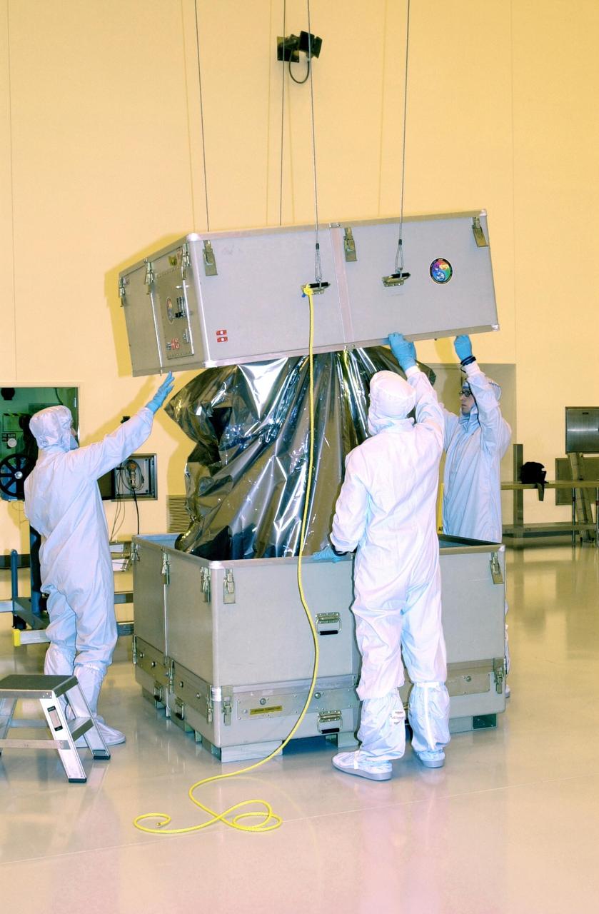 KENNEDY SPACE CENTER, FLA. - In the Multi-Purpose Processing Facility at KSC, workers unpack the Solar Radiation and Climate Experiment (SORCE) spacecraft. SORCE arrived at Kennedy Space Center Oct. 26 to begin final processing. SORCE is equipped with four instruments that will measure variations in solar radiation much more accurately than anything now in use and observe some of the spectral properties of solar radiation for the first time. With data from NASA's SORCE mission, researchers should be able to follow how the Sun affects our climate now and in the future. The SORCE project is managed by NASA's Goddard Space Flight Center. The instruments on the SORCE spacecraft are built by the Laboratory for Atmospheric and Space Physics (LASP). Launch of SORCE aboard a Pegasus XL rocket is scheduled for mid-December 2002. Launch site is Cape Canaveral Air Force Station, Fla.