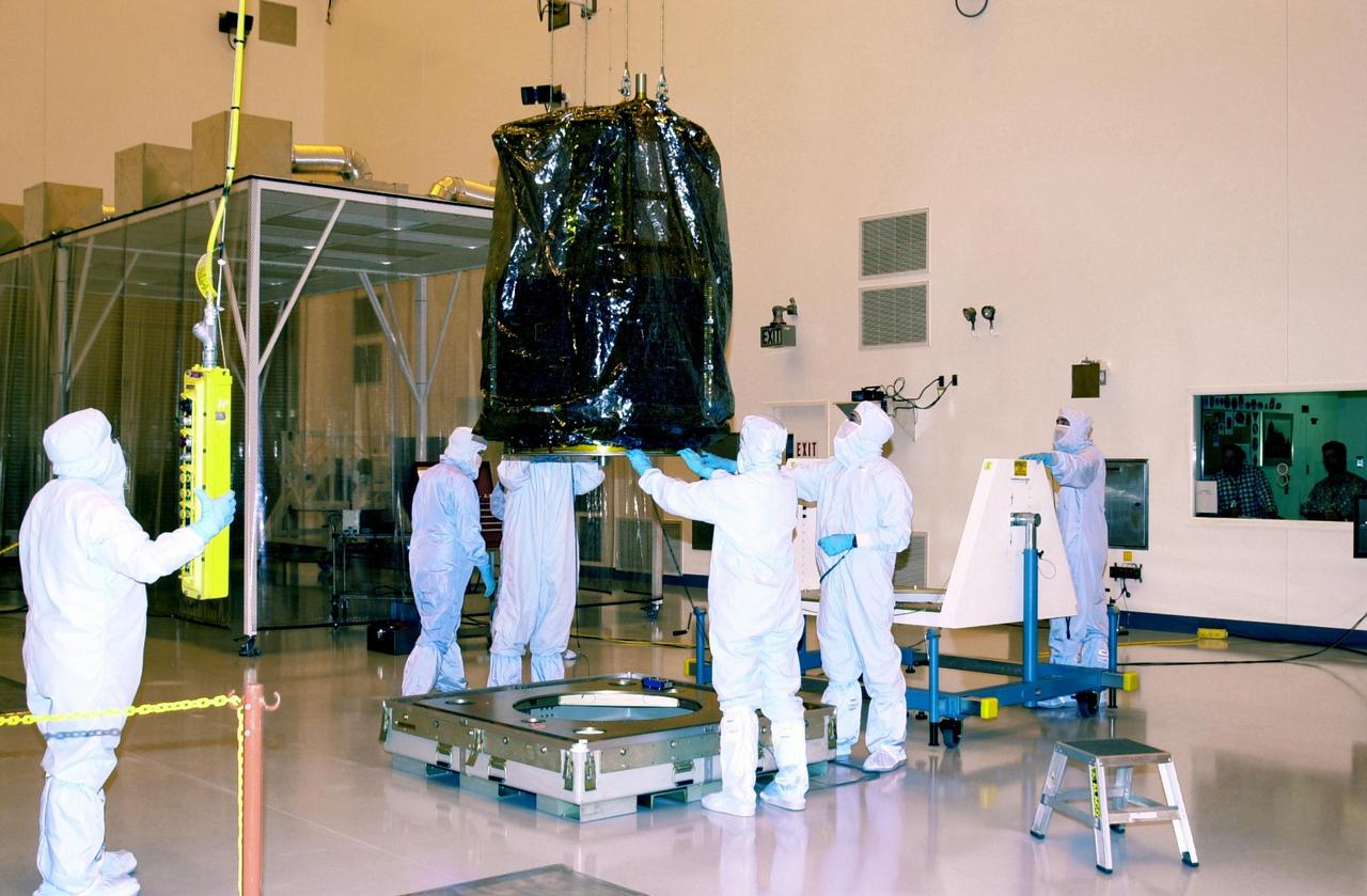 KENNEDY SPACE CENTER, FLA. --  Workers in the Multi-Purpose Processing Facility at KSC lift the Solar Radiation and Climate Experiment (SORCE) spacecraft to move it to a workstand. SORCE arrived at Kennedy Space Center Oct. 26 to begin final processing.  SORCE is equipped with four instruments that will measure variations in solar radiation much more accurately than anything now in use and observe some of the spectral properties of solar radiation for the first time. With data from NASA's SORCE mission, researchers should be able to follow how the Sun affects our climate now and in the future.  The SORCE project is managed by NASA's Goddard Space Flight Center.  The instruments on the SORCE spacecraft are built by the Laboratory for Atmospheric and Space Physics (LASP).  Launch of SORCE aboard a Pegasus XL rocket is scheduled for mid-December 2002.  Launch site is Cape Canaveral Air Force Station, Fla.