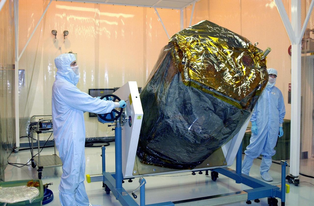 KENNEDY SPACE CENTER, FLA. -- In the Multi-Purpose Processing Facility at KSC, the Solar Radiation and Climate Experiment (SORCE) spacecraft is rotated from a vertical to horizontal position on a workstand. SORCE arrived at Kennedy Space Center Oct. 26 to begin final processing.  SORCE is equipped with four instruments that will measure variations in solar radiation much more accurately than anything now in use and observe some of the spectral properties of solar radiation for the first time. With data from NASA's SORCE mission, researchers should be able to follow how the Sun affects our climate now and in the future.  The SORCE project is managed by NASA's Goddard Space Flight Center.  The instruments on the SORCE spacecraft are built by the Laboratory for Atmospheric and Space Physics (LASP).  Launch of SORCE aboard a Pegasus XL rocket is scheduled for mid-December 2002.  Launch site is Cape Canaveral Air Force Station, Fla.