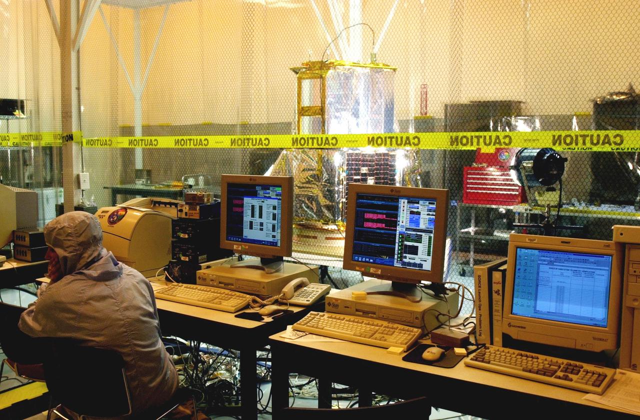 KENNEDY SPACE CENTER, FLA. - Computers in the Multi-Purpose Processing Facility monitor a solar array test on the SORCE satellite, beyond the screening. SORCE is equipped with four instruments that will measure variations in solar radiation much more accurately than anything now in use and observe some of the spectral properties of solar radiation for the first time. With data from NASA’s SORCE mission, researchers should be able to follow how the Sun affects our climate now and in the future. The SORCE project is managed by NASA’s Goddard Space Flight Center. The instruments on the SORCE spacecraft are built by the Laboratory for Atmospheric and Space Physics (LASP). Launch of SORCE aboard a Pegasus XL rocket is scheduled for mid-December 2002. Launch site is Cape Canaveral Air Force Station, Fla.