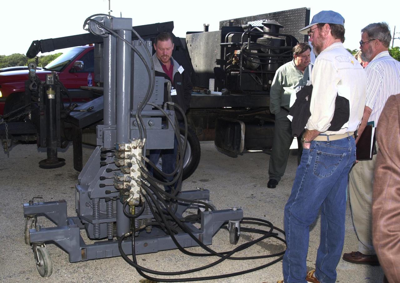 KENNEDY SPACE CENTER, FLA. - A touring group of national and international participants look over some Precision Sampling's drilling rig, new equipment being used for environmental cleanup at Launch Complex 34-A, Cape Canaveral Spaceport.    
