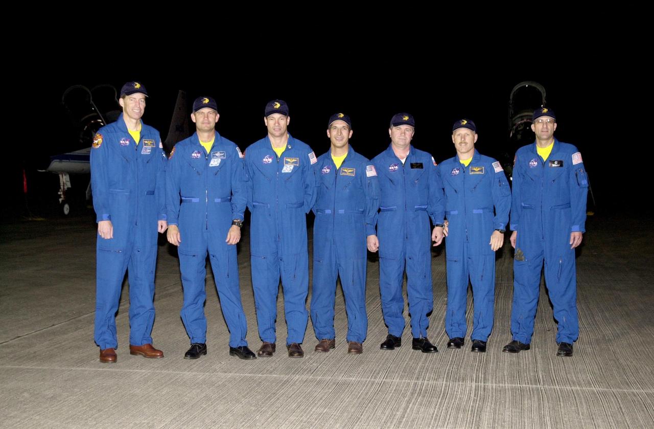 KENNEDY SPACE CENTER, FLA. - After their arrival at the KSC Shuttle Landing Facility, the crews of mission STS-113 pause for a group photo.  From left are STS-113 Commander James Wetherbee, Pilot Paul Lockhart, and Mission Specialists Michael Lopez-Alegria and John Herrington; and the Expedition 6 crew, Flight Engineer Nikolai Budarin, Commander Ken Bowersox and Flight Engineer Donald Pettit.  Budarin represents the Russian Space Agency. The primary mission of STS-113 is bringing the Expedition 6 crew to the Station and returning the Expedition 5 crew to Earth.  In addition, the major objective of the mission is delivery of the Port 1 (P1) Integrated Truss Assembly, which will be attached to the port side of the S0 truss.  Three spacewalks are planned to install and activate the truss and its associated equipment.  Launch of Space Shuttle Endeavour on mission STS-113 is scheduled for Nov. 11 between midnight and 4 a.m. EST.