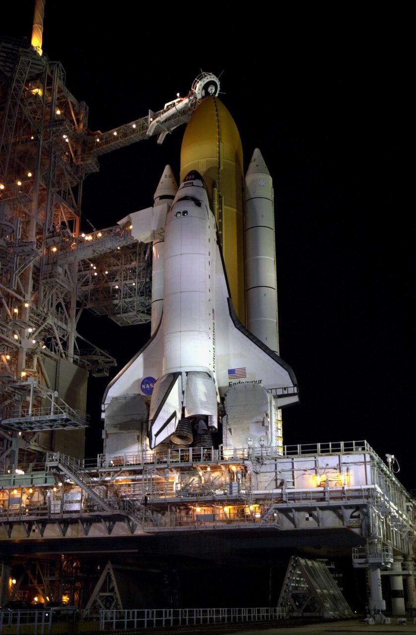 KENNEDY SPACE CENTER, FLA. -- With the Rotating Service Structure rolled back, Space Shuttle Endeavour stands ready for launch on mission STS-113. Above the golden external tank is the vent hood (known as the "beanie cap") at the end of the gaseous oxygen vent arm.  Vapors are created as the liquid oxygen in the external tank boil off.   The hood vents the gaseous oxygen vapors away from the Space Shuttle vehicle.   The Orbiter Access Arm extends from the Fixed Service Structure (FSS) to the crew compartment hatch, through which the STS-113 crew will enter Endeavour.  STS-113 is the 16th American assembly flight to the International Space Station.  The primary mission is bringing the Expedition 6 crew to the Station and returning the Expedition 5 crew to Earth.  The major objective of the mission is delivery of the Port 1 (P1) Integrated Truss Assembly, which will be attached to the port side of the S0 truss.  Three spacewalks are planned to install and activate the truss and its associated equipment.  Launch of Space Shuttle Endeavour on mission STS-113 is scheduled for Nov. 11 at 12:58 a.m. EST.  