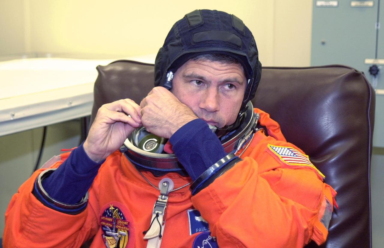 KENNEDY SPACE CENTER, FLA. --  STS-113 Paul Lockhart adjusts his helmet during suitup before launch.  Lockhart will be making his second Shuttle flight. The primary mission is bringing the Expedition 6 crew to the Station and returning the Expedition 5 crew to Earth.  The major objective of the mission is delivery of the Port 1 (P1) Integrated Truss Assembly, which will be attached to the port side of the S0 truss.  Three spacewalks are planned to install and activate the truss and its associated equipment.  Launch of Space Shuttle Endeavour on mission STS-113 is scheduled for Nov. 11 at 12:58 a.m. EST.