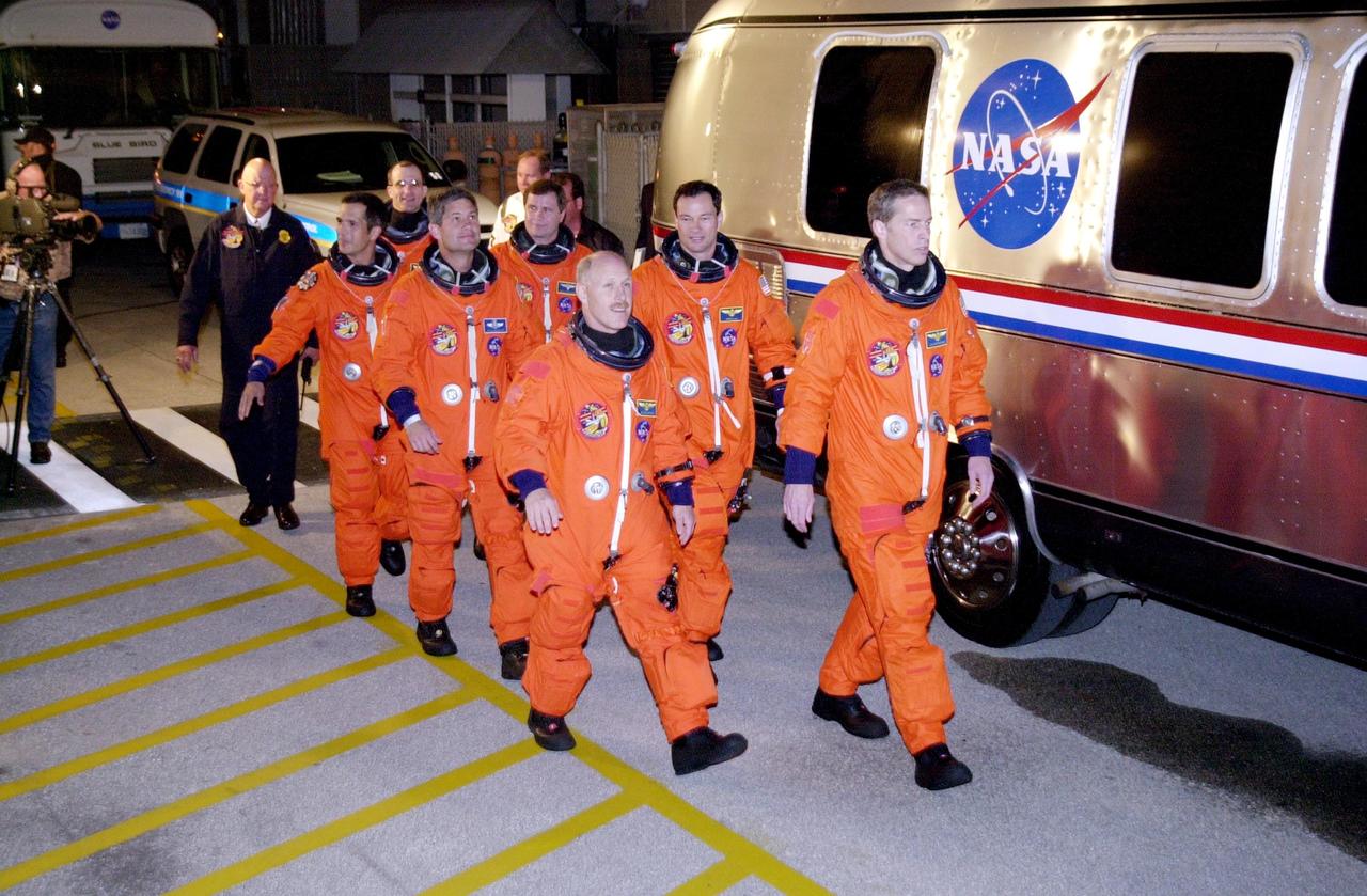 KENNEDY SPACE CENTER, FLA. --  The STS-113 and Expedition 6 crews head for the Astrovan that will take them to Launch Pad 39A and Space Shuttle Endeavour.  In the foreground, from left to right, are Mission Specialist John Herrington, Pilot Paul Lockhart and Expedition 6 Commander Ken Bowersox.  In the back, from left to right, are Expedition 6 flight engineers Donald Pettit and Nikolai Budarin, Mission Specialist Michael Lopez-Alegria and Commander James Wetherbee. The primary mission is bringing the Expedition 6 crew to the Station and returning the Expedition 5 crew to Earth.  The major objective of the mission is delivery of the Port 1 (P1) Integrated Truss Assembly, which will be attached to the port side of the S0 truss.  Three spacewalks are planned to install and activate the truss and its associated equipment.  Launch of Space Shuttle Endeavour on mission STS-113 is scheduled for Nov. 11 at 12:58 a.m. EST.