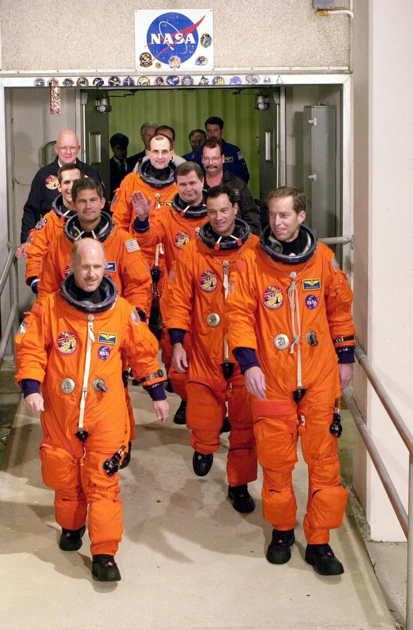 KENNEDY SPACE CENTER, FLA. -  The STS-113 and Expedition 6 crews exit the Operations and Checkout Building on their way to Launch Pad 39A and liftoff of Space Shuttle Endeavour.  From front to back are Expedition 6 Commander Ken Bowersox and Mission Commander James Wetherbee; Pilot Paul Lockhart and Mission Specialist Michael Lopez-Alegria; Mission Specialist John Herrington and Expedition 6 flight engineer Nikolai Budarin; and flight engineer Donald Pettit. The primary mission is bringing the Expedition 6 crew to the Station and returning the Expedition 5 crew to Earth.  The major objective of the mission is delivery of the Port 1 (P1) Integrated Truss Assembly, which will be attached to the port side of the S0 truss.  Three spacewalks are planned to install and activate the truss and its associated equipment.  Launch of Space Shuttle Endeavour on mission STS-113 is scheduled for Nov. 11 at 12:58 a.m. EST. 