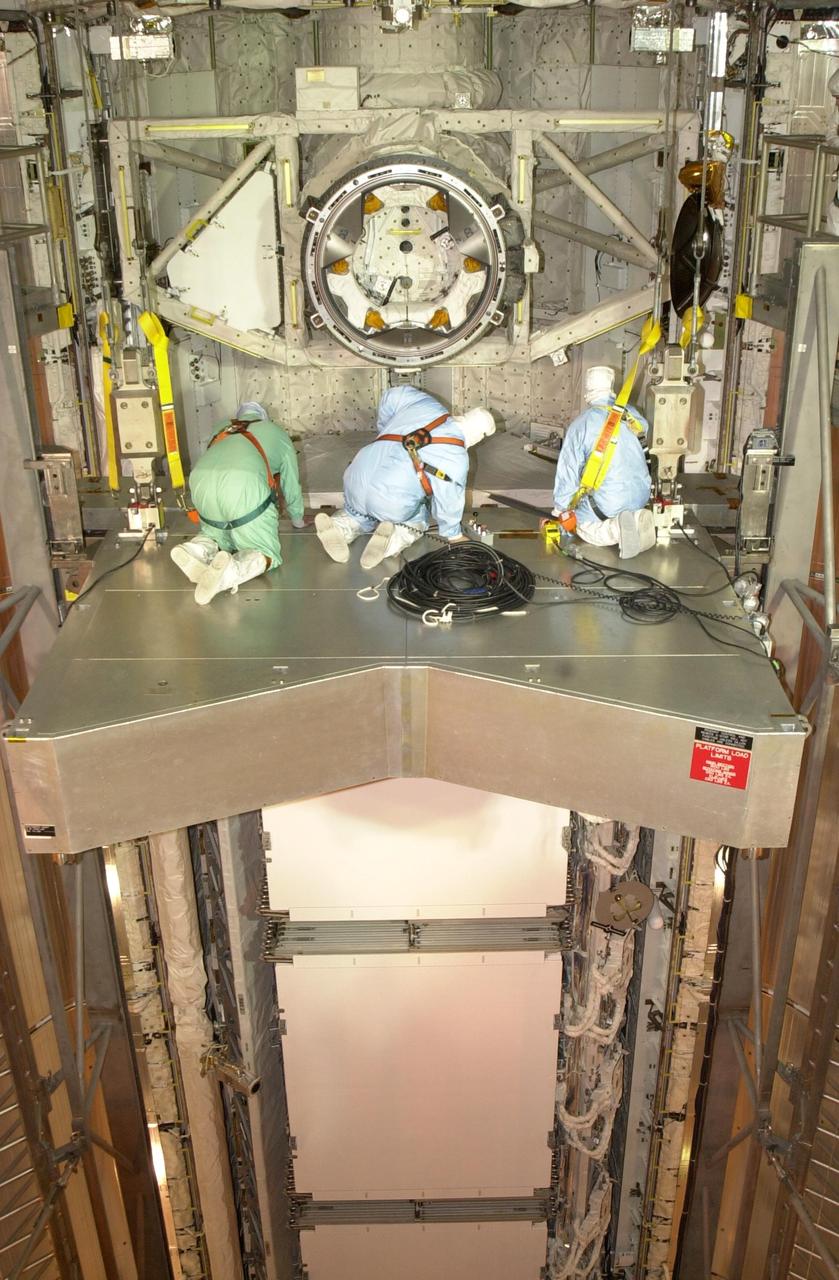 KENNEDY SPACE CENTER, FLA. --  Workers in the Payload Changeout Room, Launch Pad 39A, are on a platform in the forward cargo bay area of Space Shuttle Endeavour to search for an oxygen leak. The launch of Endeavour on mission STS-113 was postponed Nov. 10, following the completion of tanking operations, due to higher than allowable oxygen levels in the orbiter's midbody. Workers will investigate the exact location and possible cause of the leak, and effect repairs. Launch has been tentatively set for no earlier than Nov. 18, between 7 and 11 p.m. EST.