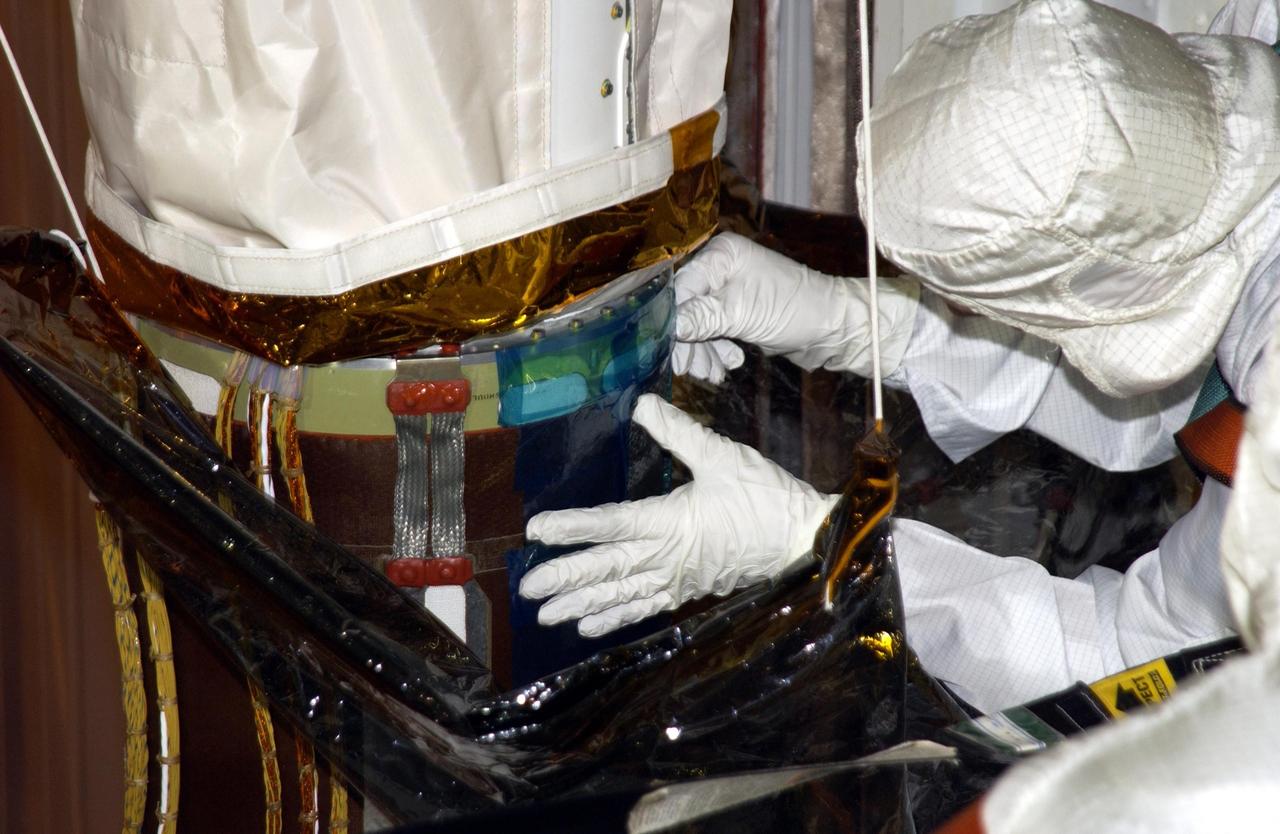 KENNEDY SPACE CENTER, FLA. -- Robotic arm experts begin inspection of a scrape on the surface of the honeycomb shell on Endeavour's robotic arm.  The scrape occurred while work platforms were being installed to gain access to repair the oxygen leak in the Shuttle's mid-body. Launch of Endeavour on mission STS-113 has been postponed until no earlier than Nov. 22.    