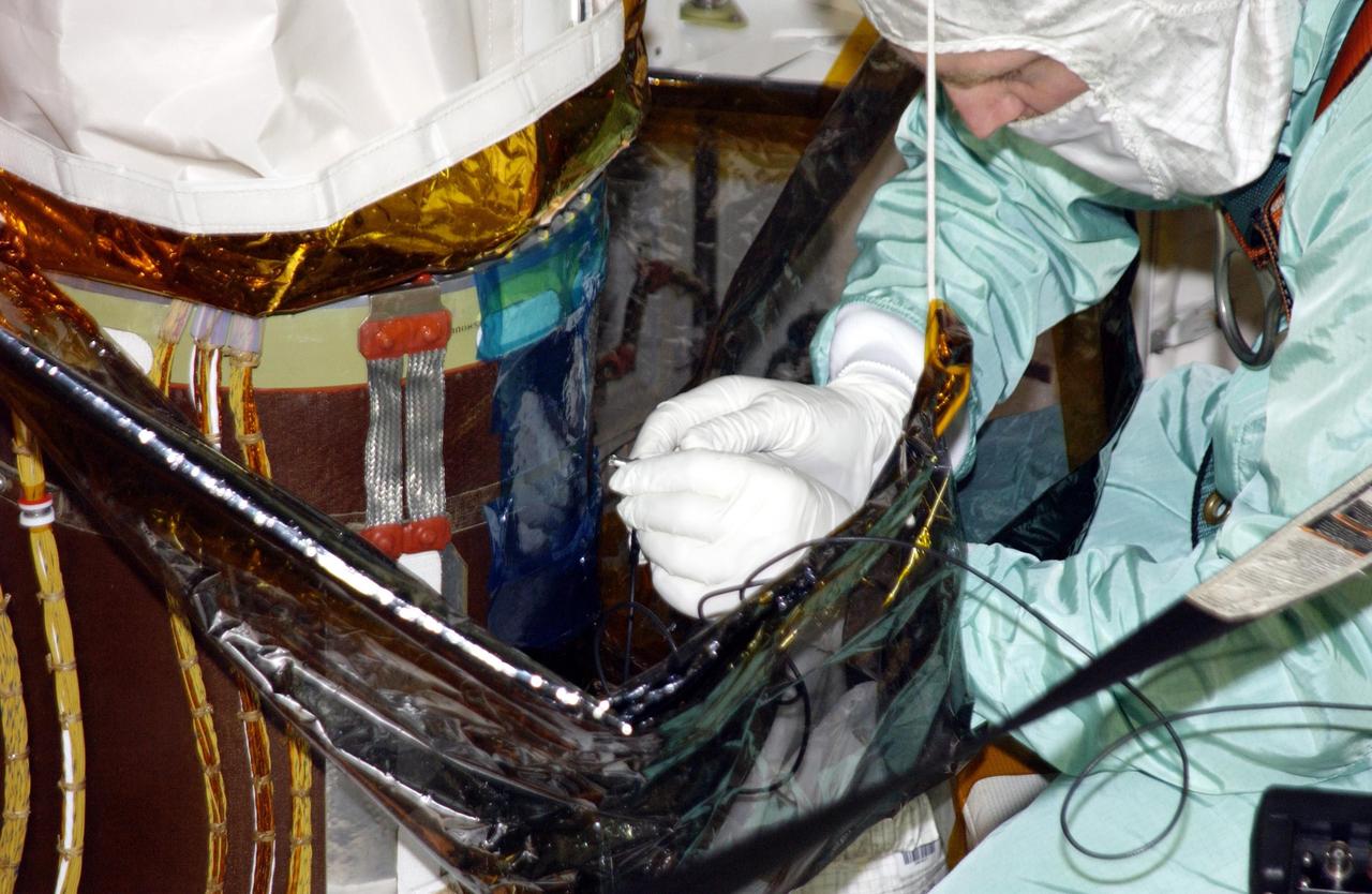 KENNEDY SPACE CENTER, FLA. -- Robotic arm experts get ready for ultrasound testing on Endeavour's robotic arm.  A scrape of the honeycomb shell around the arm occurred while work platforms were being installed to gain access to repair the oxygen leak in the Shuttle's mid-body.  Launch of Endeavour on mission STS-113 has been postponed until no earlier than Nov. 22.    
