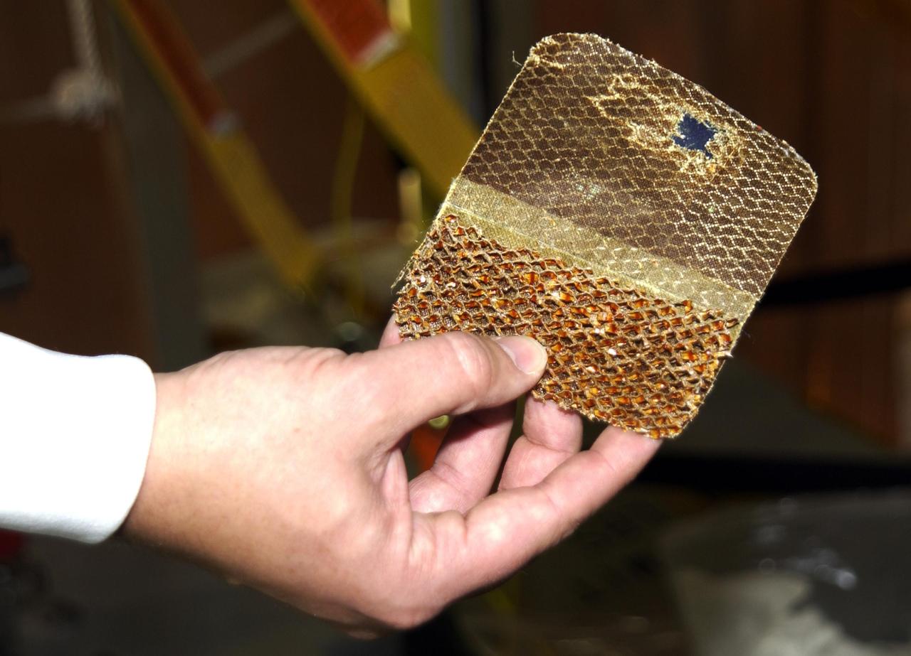 KENNEDY SPACE CENTER, FLA. --  A piece of  the honeycomb shell around Endeavour's robotic arm has been cut to inspect the arm. A scrape of the shell occurred while work platforms were being installed to gain access to repair the oxygen leak in the Shuttle's mid-body.  Launch of Endeavour on mission STS-113 has been postponed until no earlier than Nov. 22.    