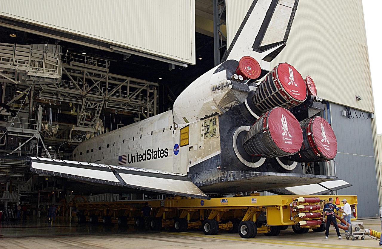 KENNEDY SPACE CENTER, FLA. -- Space Shuttle Columbia is backed out of its Orbiter Processing Facility bay as it starts its move to the Vehicle Assembly Building. The orbiter is being prepared to fly on mission STS-107 now targeted for no earlier than Jan. 16, 2003. The STS-107 mission will be dedicated to microgravity research. The payloads include the Hitchhiker Bridge, a carrier for the Fast Reaction Experiments Enabling Science, Technology, Applications and Research (FREESTAR) incorporating eight high priority secondary attached Shuttle experiments, and the SHI Research Double Module (SHI/RDM), also known as SPACEHAB.