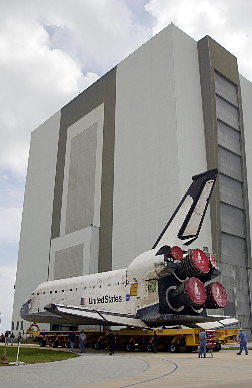 KENNEDY SPACE CENTER, FLA. -- KSC workers accompany Space Shuttle Columbia as it is moved towards the Vehicle Assembly Building where processing will continue for the flight of mission STS-107. Launch is now targeted for no earlier than Jan. 16, 2003. The STS-107 mission will be dedicated to microgravity research. The payloads include the Hitchhiker Bridge, a carrier for the Fast Reaction Experiments Enabling Science, Technology, Applications and Research (FREESTAR) incorporating eight high priority secondary attached Shuttle experiments, and the SHI Research Double Module (SHI/RDM), also known as SPACEHAB.
