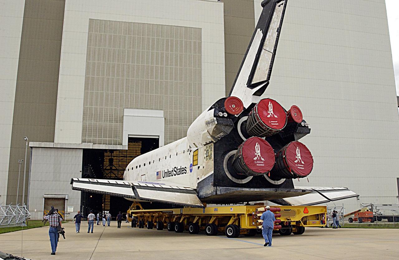 KENNEDY SPACE CENTER, FLA. -- KSC workers accompany Space Shuttle Columbia as it is moved inside the Vehicle Assembly Building where processing will continue for the flight of mission STS-107. Launch is now targeted for no earlier than Jan. 16, 2003. The STS-107 mission will be dedicated to microgravity research. The payloads include the Hitchhiker Bridge, a carrier for the Fast Reaction Experiments Enabling Science, Technology, Applications and Research (FREESTAR) incorporating eight high priority secondary attached Shuttle experiments, and the SHI Research Double Module (SHI/RDM), also known as SPACEHAB.