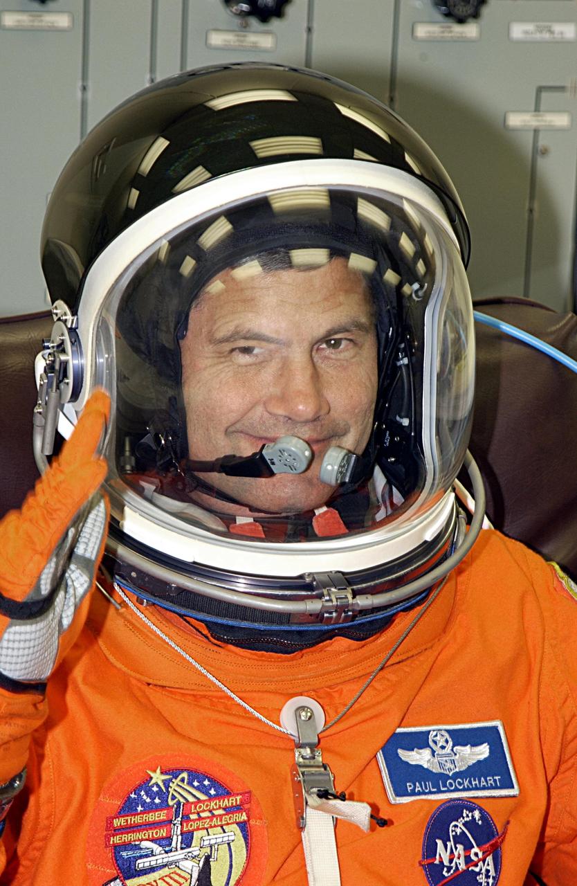 KENNEDY SPACE CENTER, FLA. - STS-113 Pilot Paul Lockhart salutes as he finishes suiting up for a second launch attempt on mission STS-113. The launch on Nov. 22 was scrubbed due to poor weather conditions at the Transoceanic Abort Landing sites. Lockhart will be making his second Shuttle flight. The launch will carry the Expedition 6 crew to the Station and return the Expedition 5 crew to Earth. The major objective of the mission is delivery of the Port 1 (P1) Integrated Truss Assembly, which will be attached to the port side of the S0 truss. Three spacewalks are planned to install and activate the truss and its associated equipment. Launch of Space Shuttle Endeavour on mission STS-113 is now scheduled for Nov. 23 at 7:50 p.m. EST.