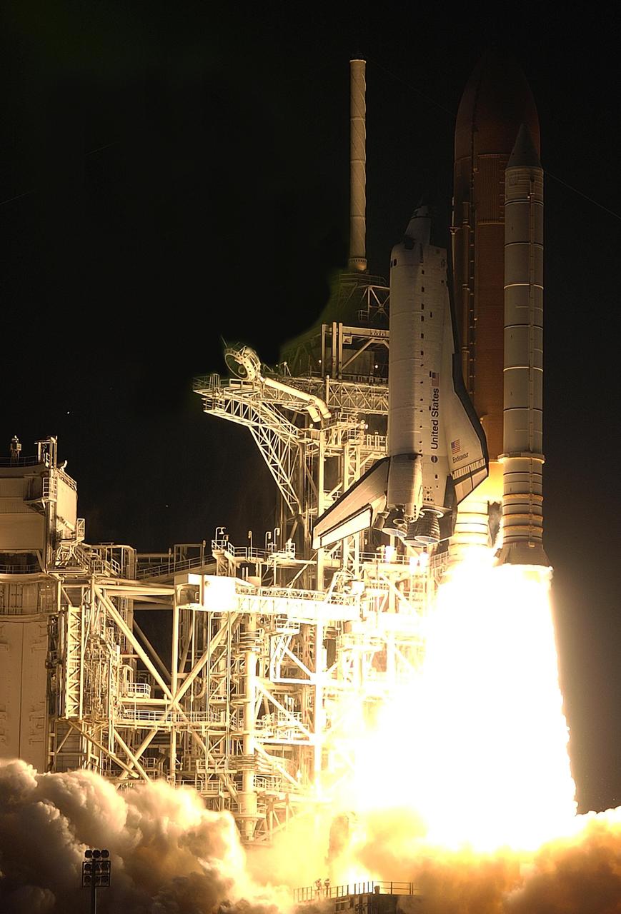 KENNEDY SPACE CENTER, FLA. --  Space Shuttle Endeavour climbs into the black sky as it lifts off Launch Pad 39A on mission STS-113. Liftoff occurred ontime at 7:49:47 p.m. EST.  The launch is the 19th for Endeavour, and the 112th flight in the Shuttle program.  Mission STS-113 is the 16th assembly flight to the International Space Station, carrying another structure for the Station, the P1 integrated truss.  Also onboard are the Expedition 6 crew, who will replace Expedition 5.  Endeavour is scheduled to land at KSC after an 11-day journey.   [Photo by Scott Andrews]            