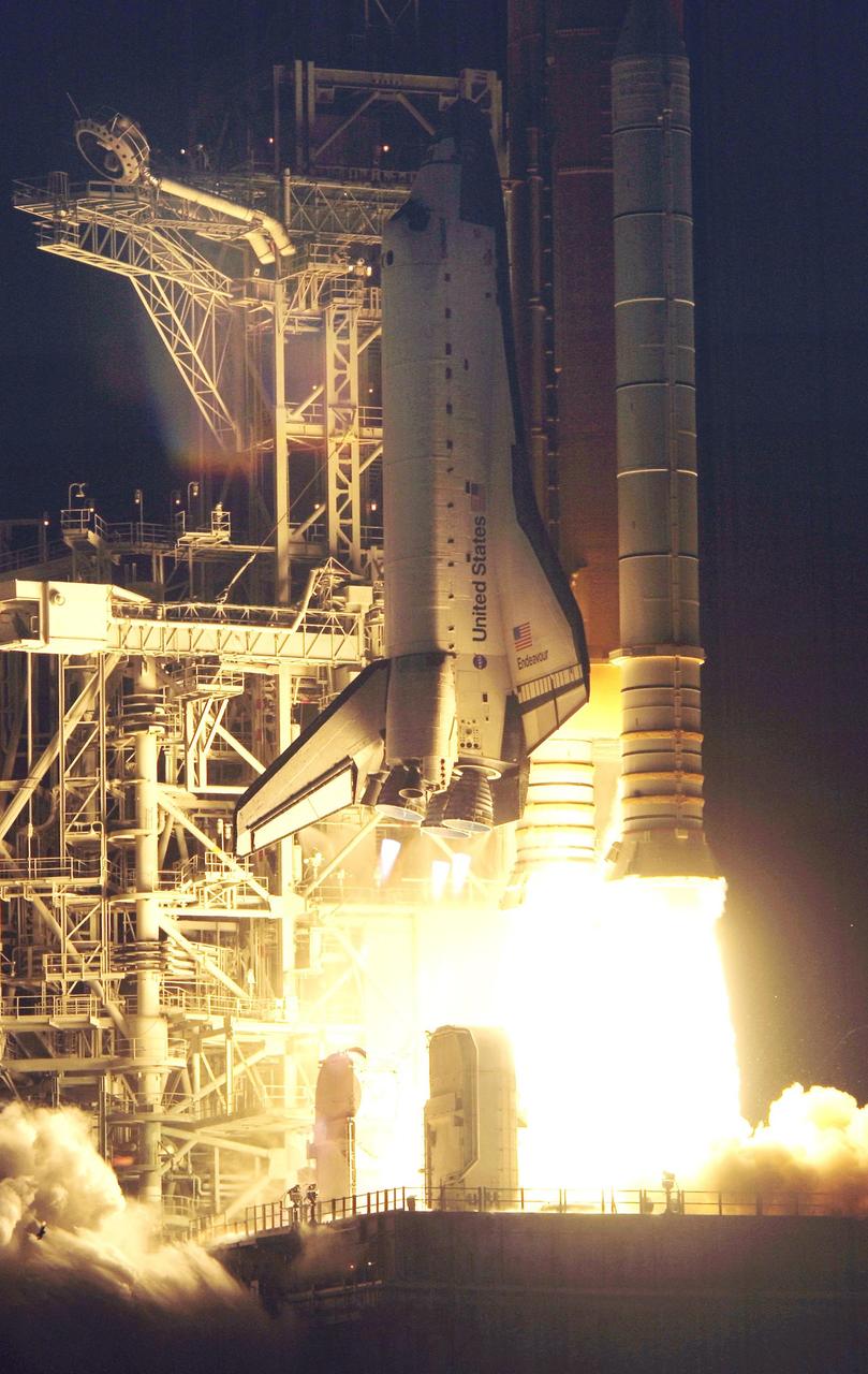 KENNEDY SPACE CENTER, FLA. -Space Shuttle Endeavour roars into the black sky on columns of fire as it lifts off Launch Pad 39A on mission STS-113. Liftoff occurred ontime at 7:49:47 p.m. EST.  The launch is the 19th for Endeavour, and the 112th flight in the Shuttle program.  Mission STS-113 is the 16th assembly flight to the International Space Station, carrying another structure for the Station, the P1 integrated truss.  Also onboard are the Expedition 6 crew, who will replace Expedition 5.  Endeavour is scheduled to land at KSC after an 11-day journey.   [Photo by Scott Andrews]            