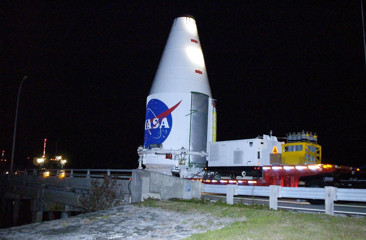 KENNEDY SPACE CENTER, FLA. -- A transporter carrying the encapsulated TDRS-J satellite crosses a bridge heading to Launch Complex 36-A, Cape Canaveral Air Force Station, for a launch Dec. 4  aboard an Atlas IIA vehicle.  The launch window is 9:42 to 10:22 p.m. EST. TDRS-J, the third in a series of telemetry satellites, will help replenish the current constellation of geosynchronous TDRS satellites that are the primary source of space-to-ground voice, data and telemetry for the Space Shuttle. The satellites also provide communications with the International Space Station and scientific spacecraft in low-Earth orbit such as the Hubble Space Telescope. This new advanced series of satellites will extend the availability of TDRS communications services until about 2017.