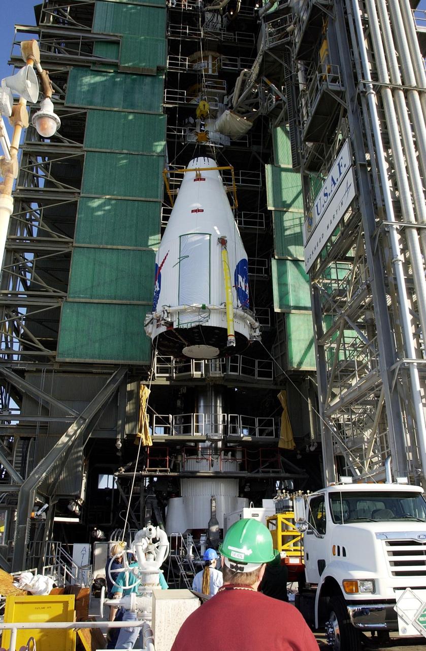 KENNEDY SPACE CENTER, FLA. - The TDRS-J satellite is lifted up the gantry on Launch Complex 36-A, Cape Canaveral Air Force Station.  The satellite is scheduled to be launched Dec. 4 aboard an Atlas IIA vehicle.  The launch window is 9:42 to 10:22 p.m. EST. TDRS-J, the third in a series of telemetry satellites, will help replenish the current constellation of geosynchronous TDRS satellites that are the primary source of space-to-ground voice, data and telemetry for the Space Shuttle. The satellites also provide communications with the International Space Station and scientific spacecraft in low-Earth orbit such as the Hubble Space Telescope. This new advanced series of satellites will extend the availability of TDRS communications services until about 2017.