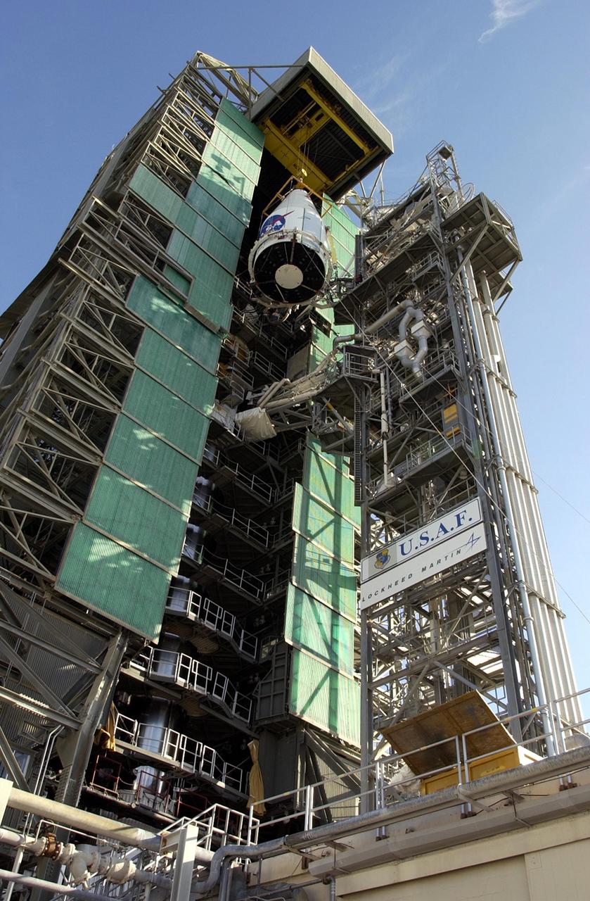 KENNEDY SPACE CENTER, FLA. -- The TDRS-J satellite nears the top of the gantry on Launch Complex 36-A, Cape Canaveral Air Force Station.  The satellite is scheduled to be launched Dec. 4 aboard an Atlas IIA vehicle.  The launch window is 9:42 to 10:22 p.m. EST. TDRS-J, the third in a series of telemetry satellites, will help replenish the current constellation of geosynchronous TDRS satellites that are the primary source of space-to-ground voice, data and telemetry for the Space Shuttle. The satellites also provide communications with the International Space Station and scientific spacecraft in low-Earth orbit such as the Hubble Space Telescope. This new advanced series of satellites will extend the availability of TDRS communications services until about 2017.  