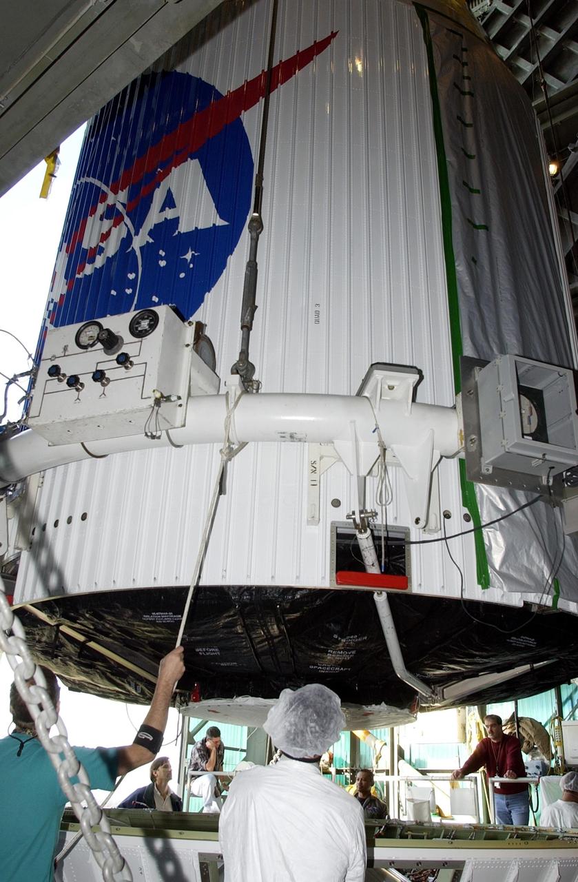 KENNEDY SPACE CENTER, FLA. --   The encapsulated TDRS-J satellite is lowered toward the Atlas IIA launch vehicle on Launch Complex 36-A, Cape Canaveral Air Force Station.  The satellite is scheduled to be launched Dec. 4 aboard an Atlas IIA vehicle.  The launch window is 9:42 to 10:22 p.m. EST. TDRS-J, the third in a series of telemetry satellites, will help replenish the current constellation of geosynchronous TDRS satellites that are the primary source of space-to-ground voice, data and telemetry for the Space Shuttle. The satellites also provide communications with the International Space Station and scientific spacecraft in low-Earth orbit such as the Hubble Space Telescope. This new advanced series of satellites will extend the availability of TDRS communications services until about 2017..  