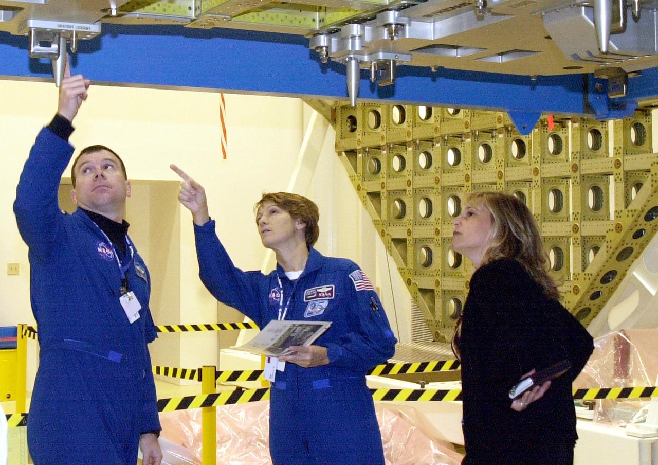 KENNEDY SPACE CENTER, FLA. - At the SPACEHAB facility in Cape Canaveral, STS-114 Pilot James Kelly (left), Commander Eileen Collins (center) and a technician participate in familiarization activities on the module that will fly on the STS-114 mission. STS-114 is a utilization and logistics flight that will carry Multi-Purpose Logistics Module Raffaello and the External Stowage Platform (ESP-2), as well as the Expedition 7 crew, to the International Space Station. Launch of STS-114 is currently targeted for March 1, 2003.