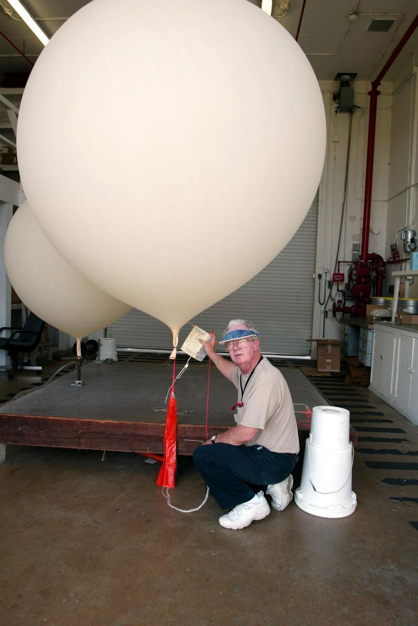KENNEDY SPACE CENTER, FLA. - Stephen Ezell, meteorological systems operator at Weather Station A, Cape Canaveral Air Force Station, gets ready to release a weather balloon. Such balloons are released twice a day collecting data such as temperature and humidity as they rise. The data is released to agencies nationwide, including the 45th Space Wing which uses the data for its daily weather reports. The weather station provides additional data to NASA for launches -- releasing 12 balloons in eight hours prior to liftoff - and landings - releasing 5 balloons in six and a half hours before expected touchdown.