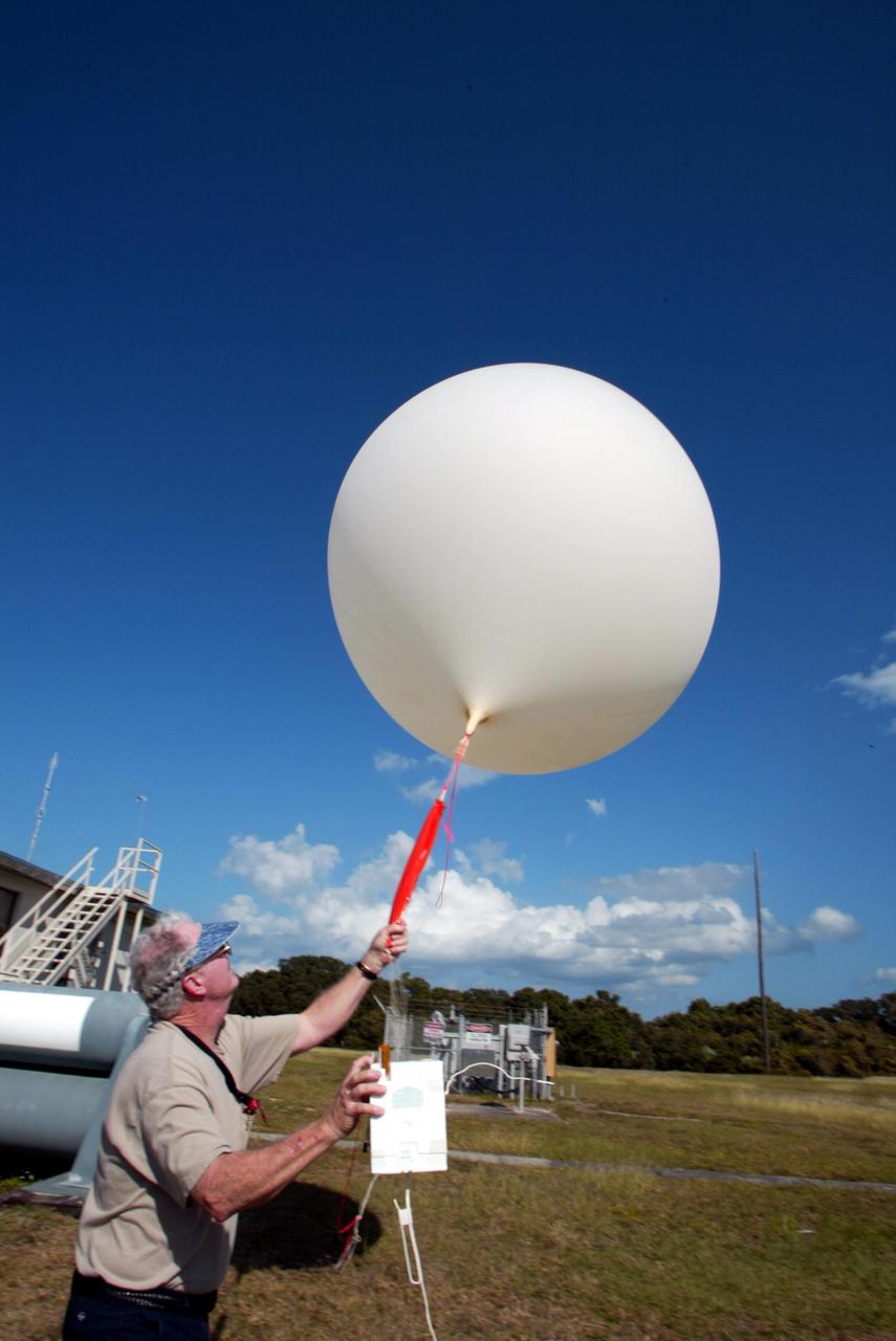 KENNEDY SPACE CENTER, FLA. - Stephen Ezell, meteorological systems operator at Weather Station A, Cape Canaveral Air Force Station, gets ready to release a weather balloon. Such balloons are released twice a day. The package in Ezell's hand is a radio sonde that collects temperature and humidity data as the balloon rises. The data is released to agencies nationwide, including the 45th Space Wing, which uses the data for its daily weather reports. The weather station provides additional data to NASA for launches -- releasing 12 balloons in eight hours prior to liftoff - and landings - releasing 5 balloons in six and a half hours before expected touchdown.