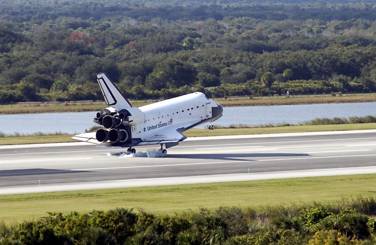 KENNEDY SPACE CENTER, FLA. - Space Shuttle Endeavour's wheels make first contact with runway 33 at the Shuttle Landing Facility after completing the 13-day, 18-hour, 48-minute, 5.74-million mile STS-113 mission to the International Space Station. Main gear touchdown was at 2:37:12 p.m. EST, nose gear touchdown was at 2:37:23 p.m., and wheel stop was at 2:38:25 p.m. Poor weather conditions thwarted landing opportunities until a fourth day, the first time in Shuttle program history that a landing has been waved off for three consecutive days. The vehicle carries the STS-113 crew, Commander James Wetherbee, Pilot Paul Lockhart and Mission Specialists Michael Lopez-Alegria and John Herrington, as well as the returning Expedition Five crew, Commander Valeri Korzun, ISS Science Officer Peggy Whitson and Flight Engineer Sergei Treschev. The installation of the P1 truss on the International Space Station was accomplished during the mission.
