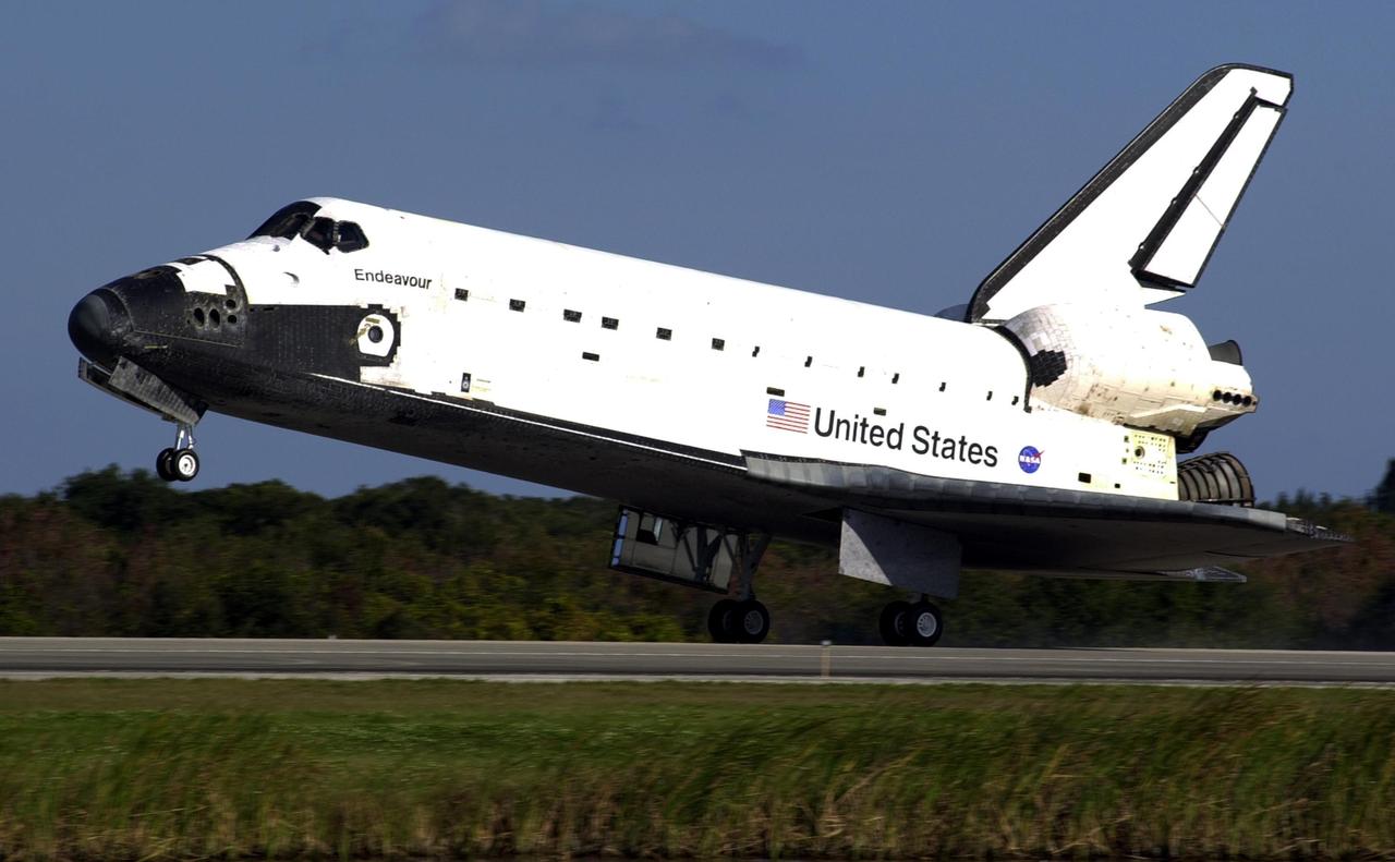 KENNEDY SPACE CENTER, FLA. - Space Shuttle Endeavour touches down on runway 33 at the Shuttle Landing Facility (SLF) after completing the 13-day, 18-hour, 48-minute, 5.74-million mile STS-113 mission to the International Space Station. Main gear touchdown was at 2:37:12 p.m. EST, nose gear touchdown was at 2:37:23 p.m., and wheel stop was at 2:38:25 p.m. Poor weather conditions thwarted landing opportunities until a fourth day, the first time in Shuttle program history that a landing has been waved off for three consecutive days. The vehicle carries the STS-113 crew, Commander James Wetherbee, Pilot Paul Lockhart and Mission Specialists Michael Lopez-Alegria and John Herrington, as well as the returning Expedition Five crew, Commander Valeri Korzun, ISS Science Officer Peggy Whitson and Flight Engineer Sergei Treschev. The installation of the P1 truss on the International Space Station was accomplished during the mission.