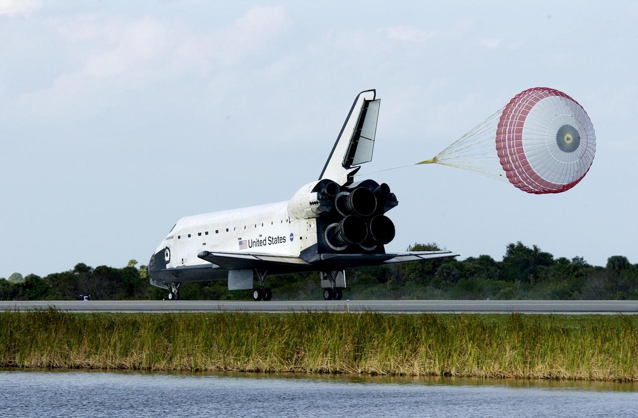 KENNEDY SPACE CENTER, FLA. -  Space Shuttle Endeavour's drag chute slows down the orbiter as it lands on runway 33 at the Shuttle Landing Facility after completing the 13-day, 18-hour, 48-minute, 5.74-million mile STS-113 mission to the International Space Station. Main gear touchdown was at 2:37:12 p.m. EST, nose gear touchdown was at 2:37:23 p.m., and wheel stop was at 2:38:25 p.m. Poor weather conditions thwarted landing opportunities until a fourth day, the first time in Shuttle program history that a landing has been waved off for three consecutive days. The vehicle carries the STS-113 crew, Commander James Wetherbee, Pilot Paul Lockhart and Mission Specialists Michael Lopez-Alegria and John Herrington, as well as the returning Expedition Five crew, Commander Valeri Korzun, ISS Science Officer Peggy Whitson and Flight Engineer Sergei Treschev. The installation of the P1 truss on the International Space Station was accomplished during the mission.