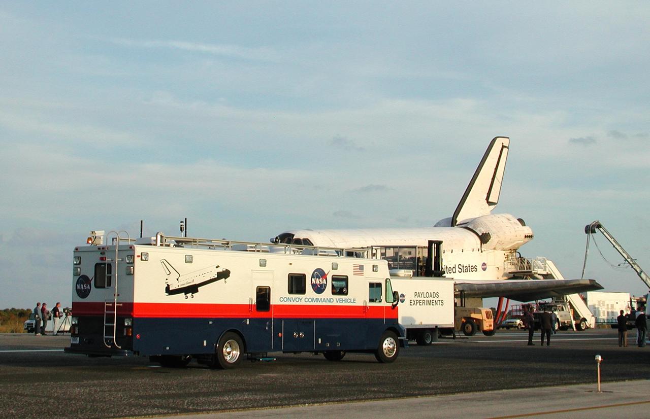 KENNEDY SPACE CENTER, FLA. -  Space Shuttle Endeavour is surrounded by vehicles from the landing convoy on runway 33 at the Shuttle Landing Facility at the conclusion of the 13-day, 18-hour, 48-minute, 5.74-million mile STS-113 mission to the International Space Station. In the foreground is the Convoy Command Vehicle which is the command post for the Convoy Commander.  The Convoy Commander is in communication with the orbiter and all of the landing convoy vehicles during the post-landing operations.  The landing convoy's purpose is to safe the vehicle and provide support for the disembarking crew and experiments.  Main gear touchdown was at 2:37:12 p.m. EST, nose gear touchdown was at 2:37:23 p.m., and wheel stop was at 2:38:25 p.m. Poor weather conditions thwarted landing opportunities until a fourth day, the first time in Shuttle program history that a landing has been waved off for three consecutive days. The vehicle carries the STS-113 crew, Commander James Wetherbee, Pilot Paul Lockhart and Mission Specialists Michael Lopez-Alegria and John Herrington, as well as the returning Expedition Five crew, Commander Valeri Korzun, ISS Science Officer Peggy Whitson and Flight Engineer Sergei Treschev. The installation of the P1 truss on the International Space Station was accomplished during the mission.
