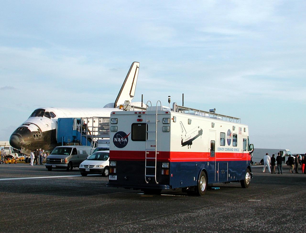 KENNEDY SPACE CENTER, FLA. -  Space Shuttle Endeavour is surrounded by vehicles from the landing convoy on runway 33 at the Shuttle Landing Facility at the conclusion of the 13-day, 18-hour, 48-minute, 5.74-million mile STS-113 mission to the International Space Station. In the foreground is the Convoy Command Vehicle which is the command post for the Convoy Commander.  The Convoy Commander is in communication with the orbiter and all of the landing convoy vehicles during the post-landing operations.  The landing convoy's purpose is to safe the vehicle and provide support for the disembarking crew and experiments.  Main gear touchdown was at 2:37:12 p.m. EST, nose gear touchdown was at 2:37:23 p.m., and wheel stop was at 2:38:25 p.m. Poor weather conditions thwarted landing opportunities until a fourth day, the first time in Shuttle program history that a landing has been waved off for three consecutive days. The vehicle carries the STS-113 crew, Commander James Wetherbee, Pilot Paul Lockhart and Mission Specialists Michael Lopez-Alegria and John Herrington, as well as the returning Expedition Five crew, Commander Valeri Korzun, ISS Science Officer Peggy Whitson and Flight Engineer Sergei Treschev. The installation of the P1 truss on the International Space Station was accomplished during the mission.