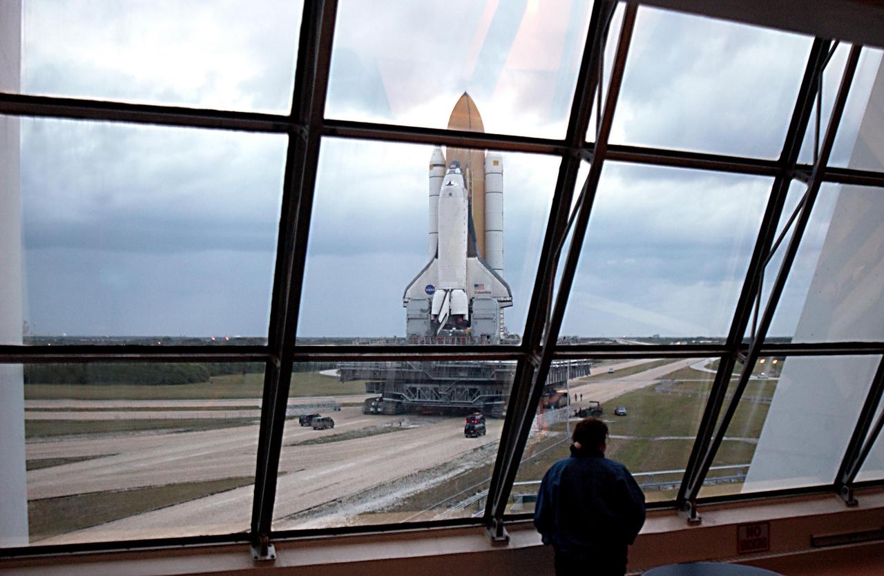 KENNEDY SPACE CENTER, FLA. -- A view from inside the Launch Control Center shows Space Shuttle Columbia rolling to Launch Pad 39A, sitting atop the Mobile Launcher Platform, which in turn is carried by the crawler-transporter underneath. The STS-107 research mission comprises experiments ranging from material sciences to life sciences (many rats), plus the Fast Reaction Experiments Enabling Science, Technology, Applications and Research (FREESTAR) that incorporates eight high priority secondary attached shuttle experiments. Mission STS-107 is scheduled to launch Jan. 16, 2003.