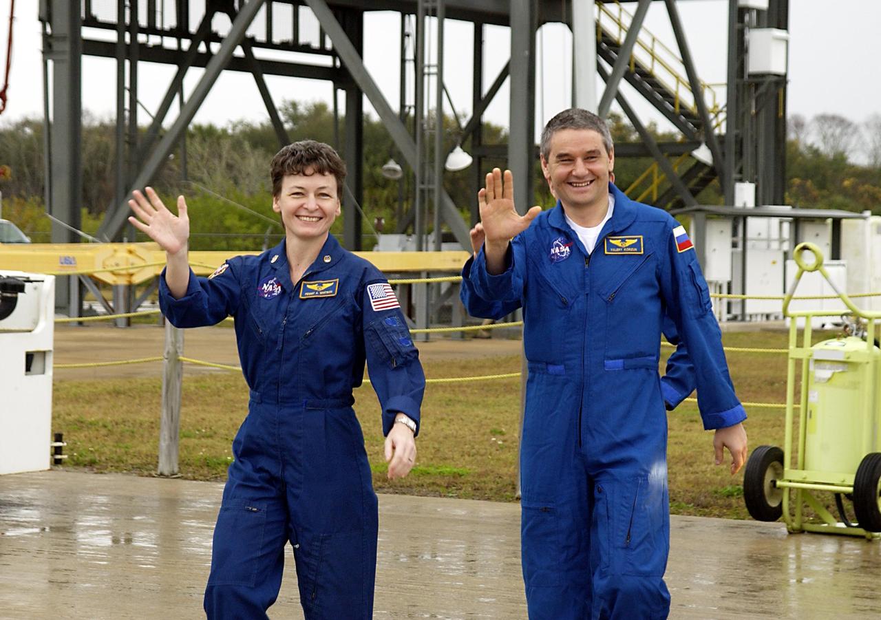 KENNEDY SPACE CENTER, FLA. -- Expedition Five crew members wave to onlookers as they leave KSC for Houston.  From left are Science Officer Peggy Whitson and Commander Valery Korzun.   Not seen is Flight Engineer Sergei Treschev.  The three returned to Earth Dec. 7 on Endeavour, with the STS-113 crew, after six months on the International Space Station.    