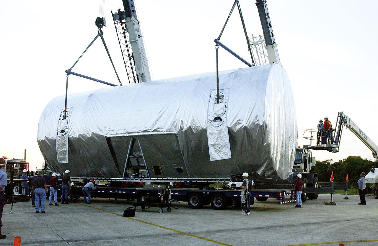 KENNEDY SPACE CENTER, FLA. -- KSC technicians supervise the transfer of the Integrated Equipment Assembly (IEA), one of two major components of the Starboard 6 (S6) truss segment for the International Space Station (ISS), onto a cargo transporter following its arrival at the Shuttle Landing Facility. The IEA will be joined to its companion piece, the Long Spacer, before launch early in 2004.  The S6 truss segment will be the 11th and final piece of the Station's Integrated Truss Structure and will support the fourth and final set of solar arrays, batteries, and electronics. 
