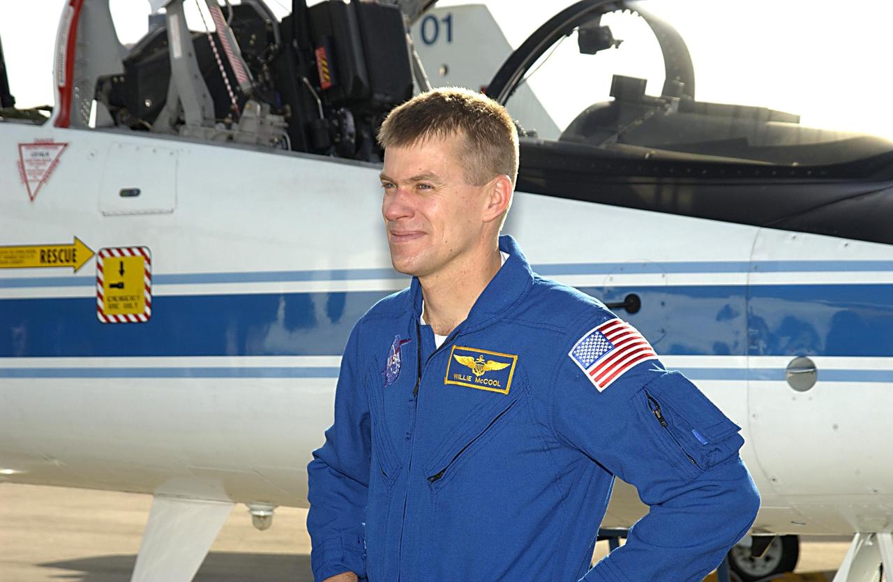 KENNEDY SPACE CENTER, FLA. - STS-107 Pilot William "Willie" McCool pauses next to the T-38 jet aircraft in which he flew to KSC.  He and the crew are at KSC to take part in Terminal Countdown Demonstration Test activities, which include a simulated launch countdown.   Other crew members are Commander Rick Husband, Payload Commander Michael Anderson, Mission Specialists Kalpana Chawla, David Brown and Laurel Clark, and Payload Specialist Ilan Ramon, the first Israeli astronaut.  STS-107 is a mission devoted to research and will include more than 80 experiments that will study Earth and space science, advanced technology development, and astronaut health and safety.  Launch is scheduled for Jan. 16, 2003.