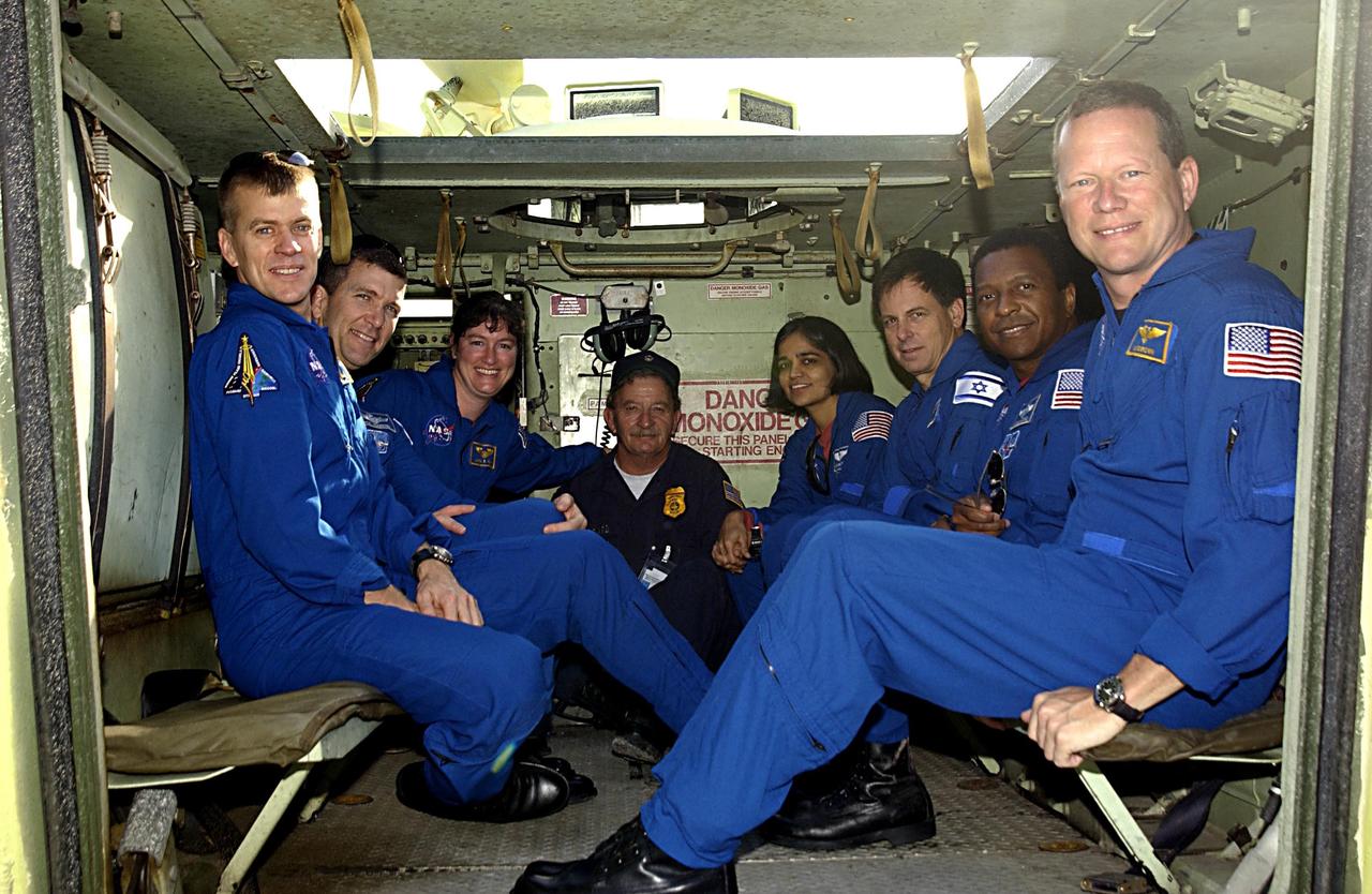 KENNEDY SPACE CENTER, FLA. -- The STS-107 crew poses for a group portrait with their instructor inside an M113 armored personnel carrier. The crew is participating in Terminal Countdown Demonstration Test activities, a standard part of launch preparations. From left to right are Pilot William "Willie" McCool, Commander Rick Husband, Mission Specialist Laurel Clark, Instructor George Hoggard, Mission Specialist Kalpana Chawla, Payload Specialist Ilan Ramon (the first Israeli astronaut), Payload Commander Michael Anderson, and Mission Specialist David Brown. STS-107 is a mission devoted to research and will include more than 80 experiments that will study Earth and space science, advanced technology development, and astronaut health and safety. Launch is planned for Jan. 16, 2003, between 10 a.m. and 2 p.m. EST aboard Space Shuttle Columbia.